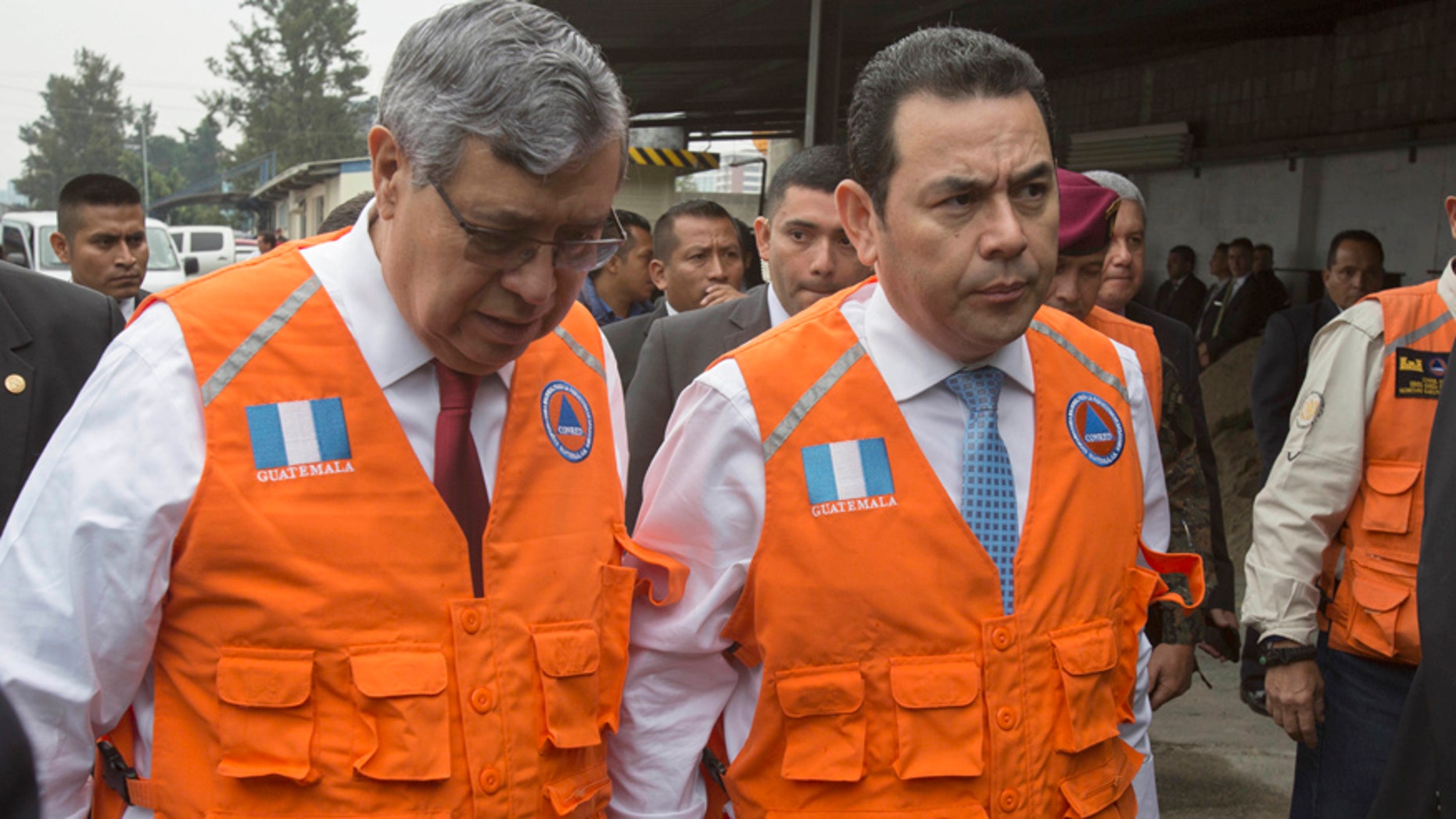 Guatemala's President Jimmy Morales, right, accompanied by his Vice-President Jafeth Cabrera talk as they arrive to National Emergency Coordination Agency's headquarters in Guatemala City, Wednesday, June 14, 2017. Morales says two people died in a magnitude 6.9 earthquake in western Guatemala near the border with Mexico on Wednesday. (AP Photo/Moises Castillo)