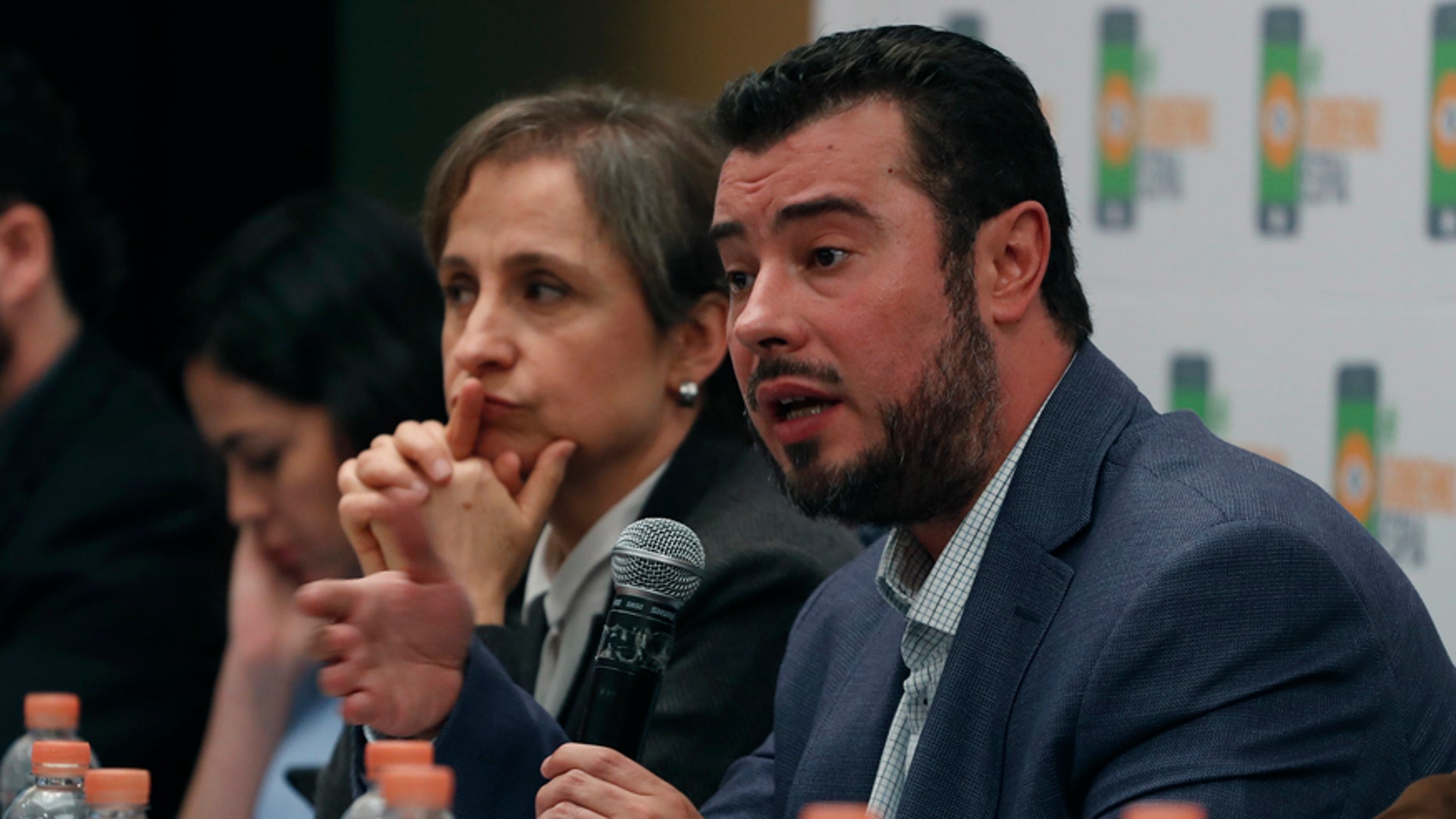 Mario Patron Sanchez, director of the Miguel Agustín Pro Juárez Center for Human Rights, talks during a news conference, seated next to Mexican journalist Carmen Aristegui, in Mexico City on Monday.