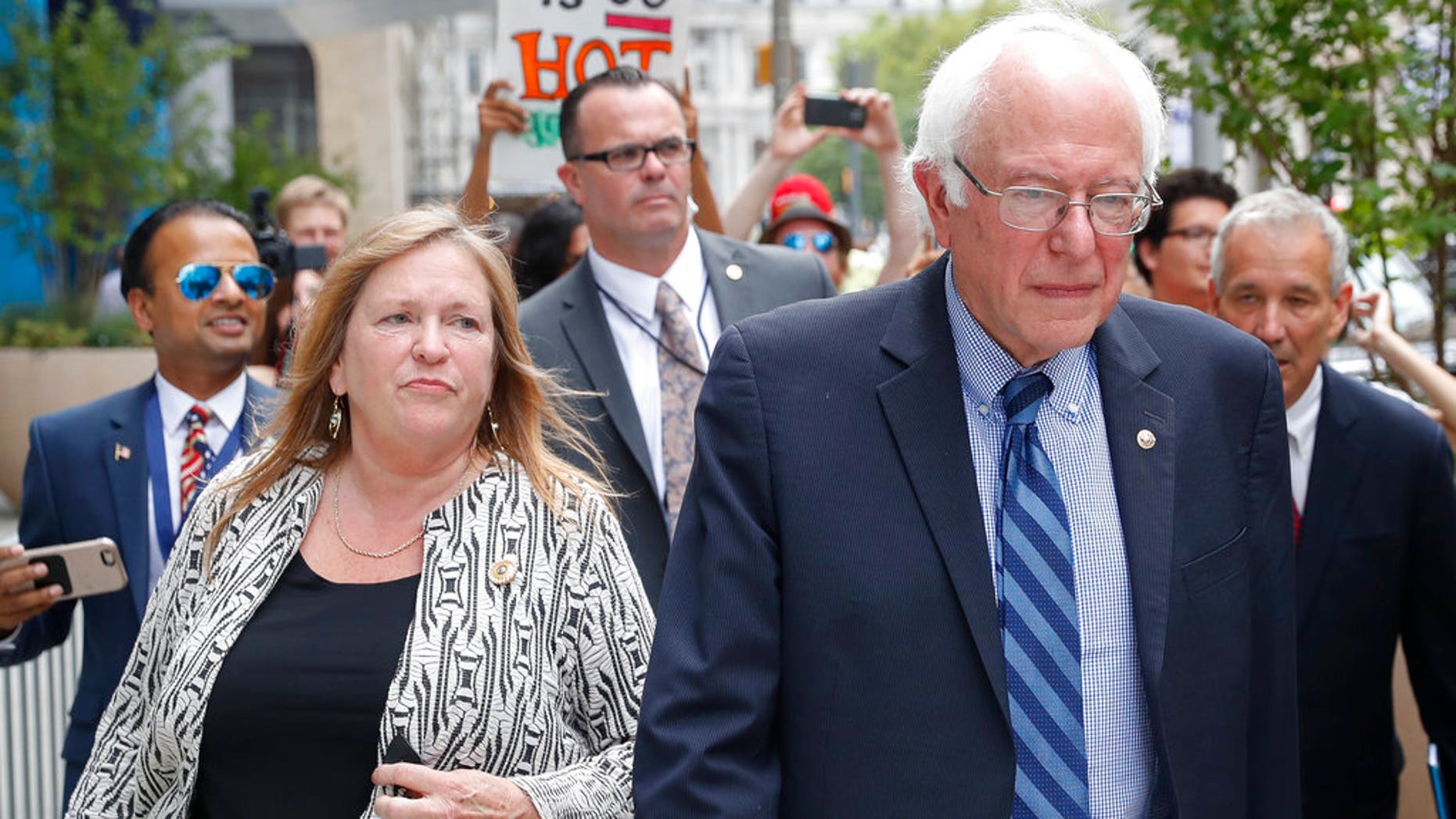 FILE--In this July 28, 2016 file photo, Sen. Bernie Sanders, I-Vt. and his wife Jane walk through downtown in Philadelphia during the final day of the Democratic National Convention. Sanders and his wife Jane O'Meara Sanders have hired lawyers in the face of federal investigations into the finances of the now-defunct Burlington College, which closed last year due, many feel, to debts incurred when Jane Sanders entered into an ill-advised real estate deal. (AP Photo/John Minchillo, File)
