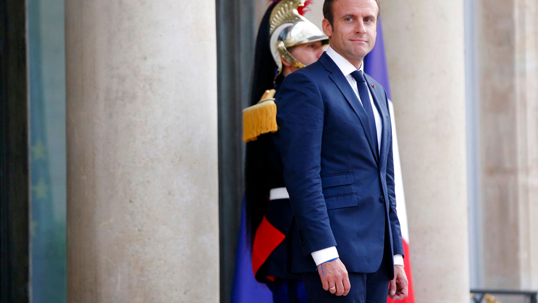 France's President Emmanuel Macron waits prior to welcoming Mexico's President Enrique Pena Nieto, for a dinner at the Elysee Palace, in Paris, Thursday, July 6, 2017. (AP Photo/Thibault Camus)