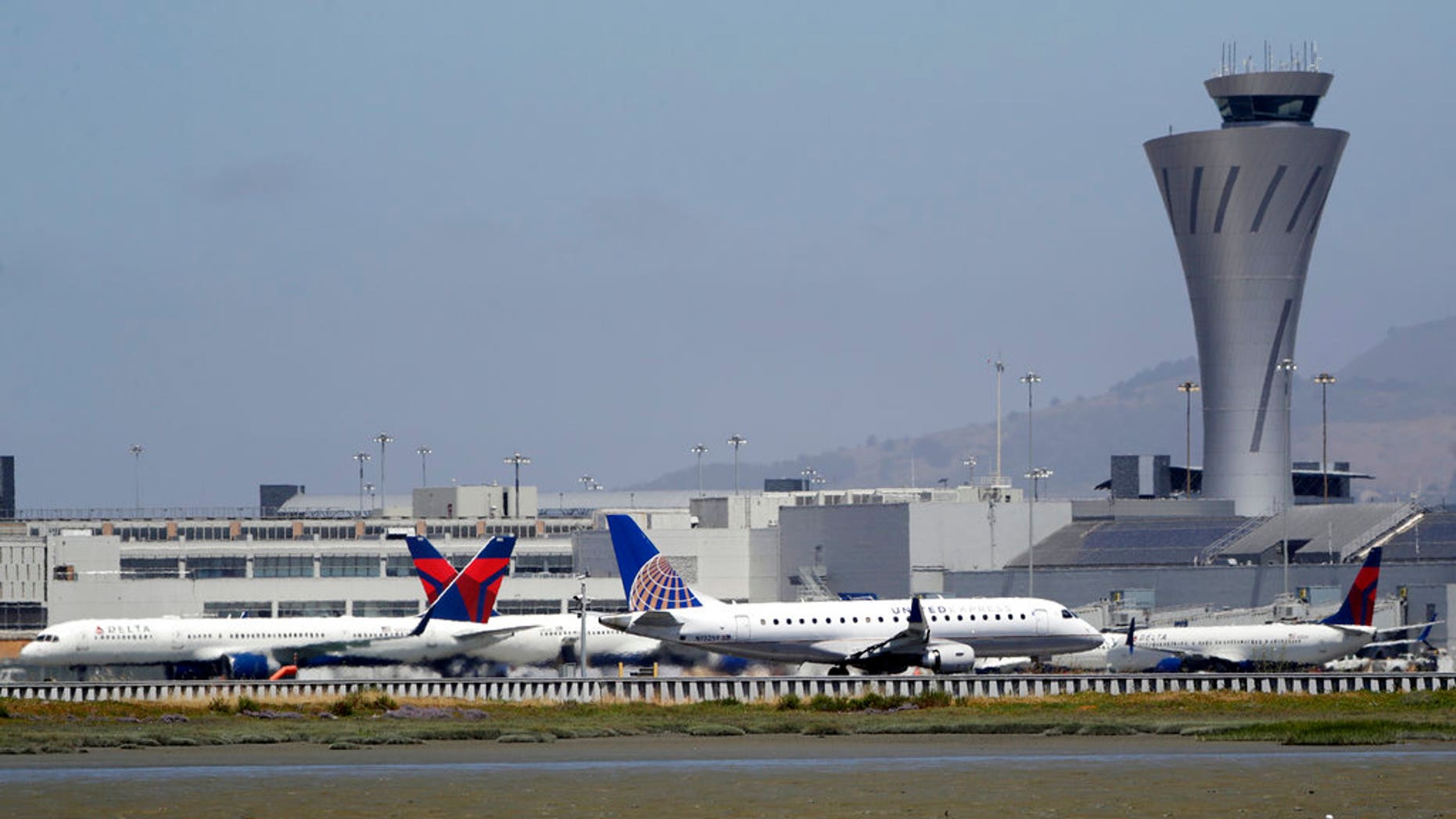 July 11, 2017: Departing and parked aircraft intersect at San Francisco International Airport.