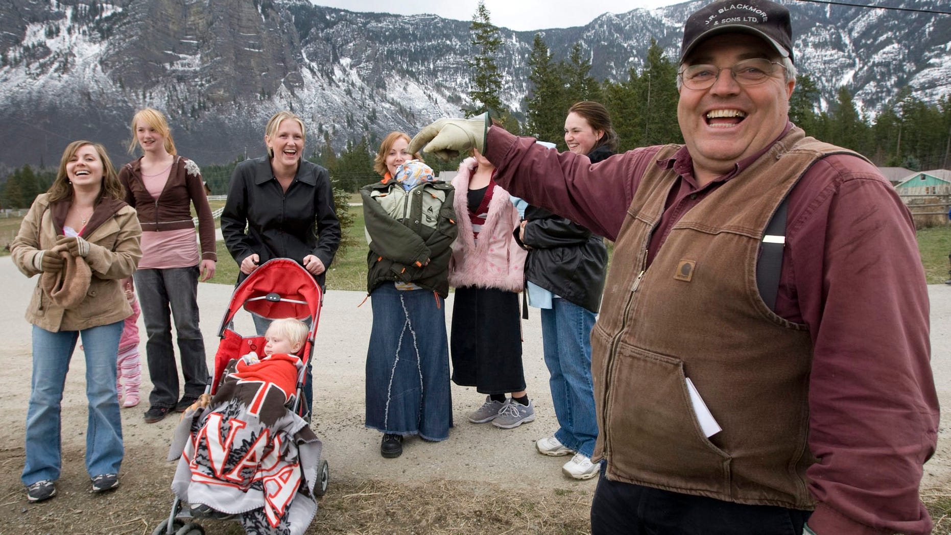 In this April 21, 2008, file photo, Winston Blackmore with six of his daughters and some of his grandchildren.
