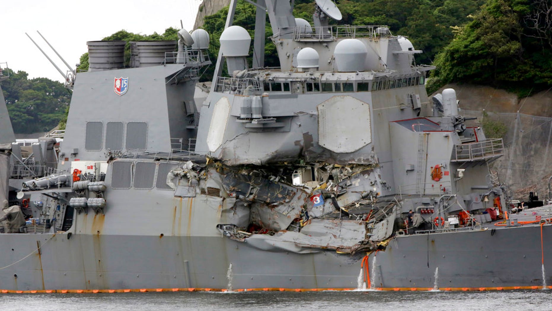 In this June 18, 2017, photo, damaged USS Fitzgerald is docked at the U.S. Naval base in Yokosuka, southwest of Tokyo, after colliding with Philippine-flagged container ship ACX Crystal off Japan.