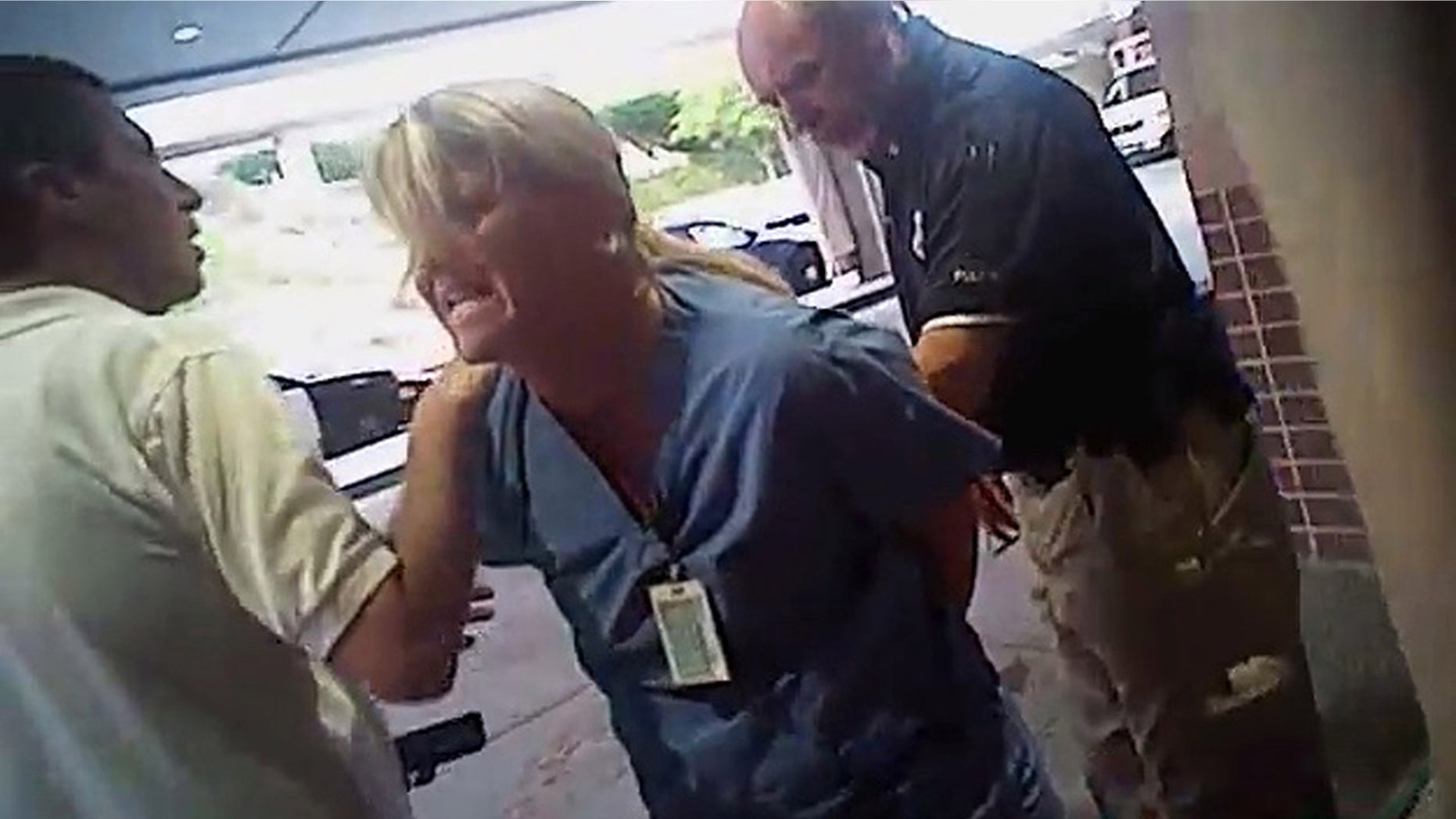 July 26, 2017: In this frame grab from video taken from a police body camera provided by attorney Karra Porter, nurse Alex Wubbels is arrested by a Salt Lake City police officer at University Hospital in Salt Lake City.