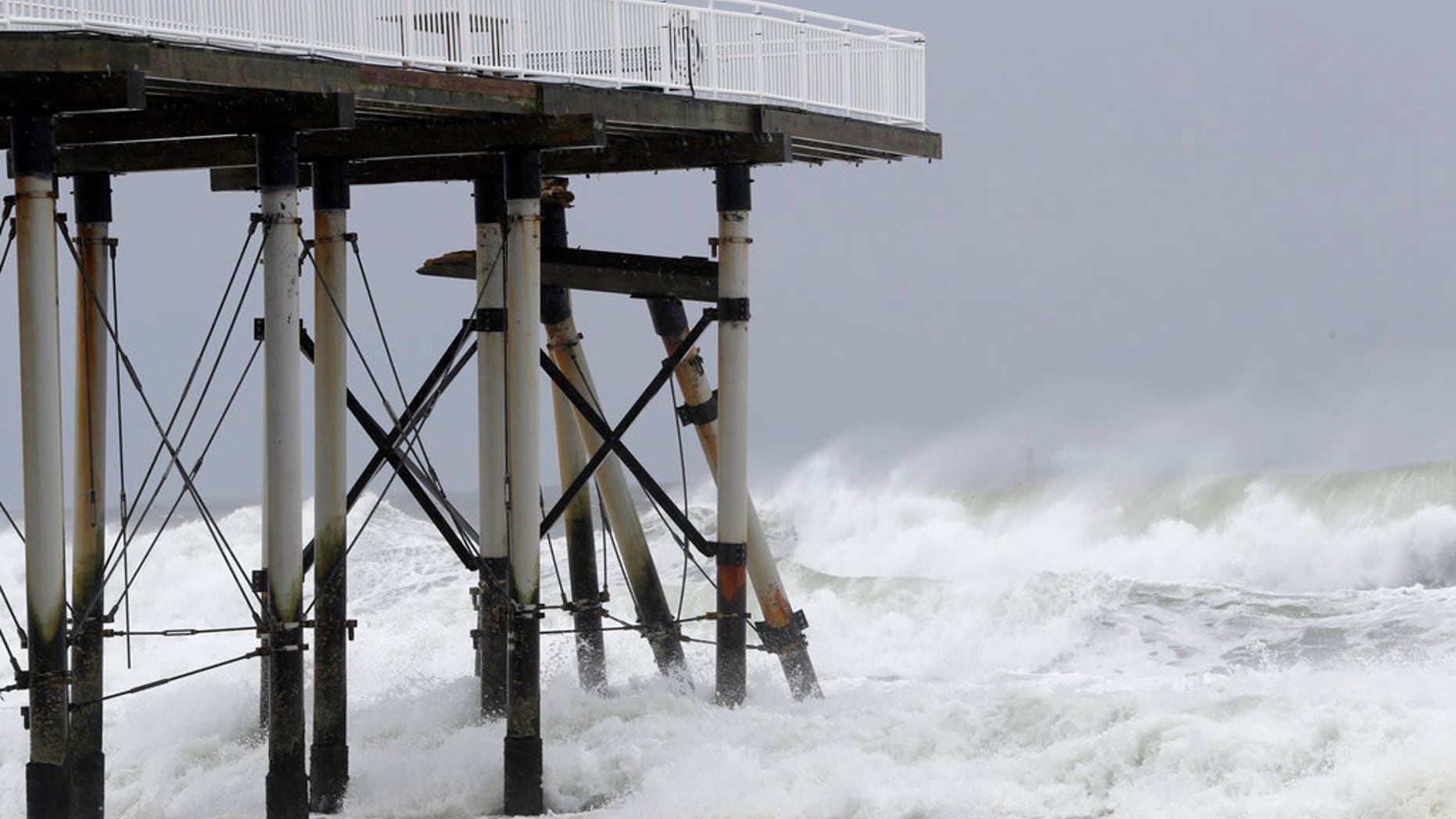 Support beams from a fishing pier lean onto others after breaking off from the platform as the effects of Jose hit New Jersey earlier this week.