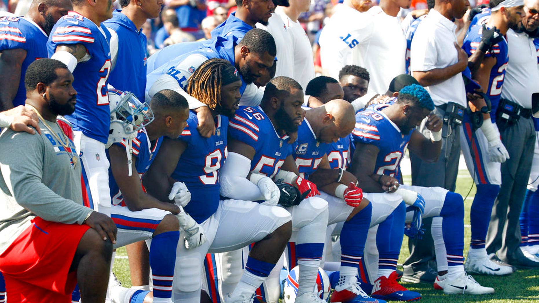 Buffalo Bills players take a knee during the national anthem Sept. 24 ahead of their game against the Denver Broncos.