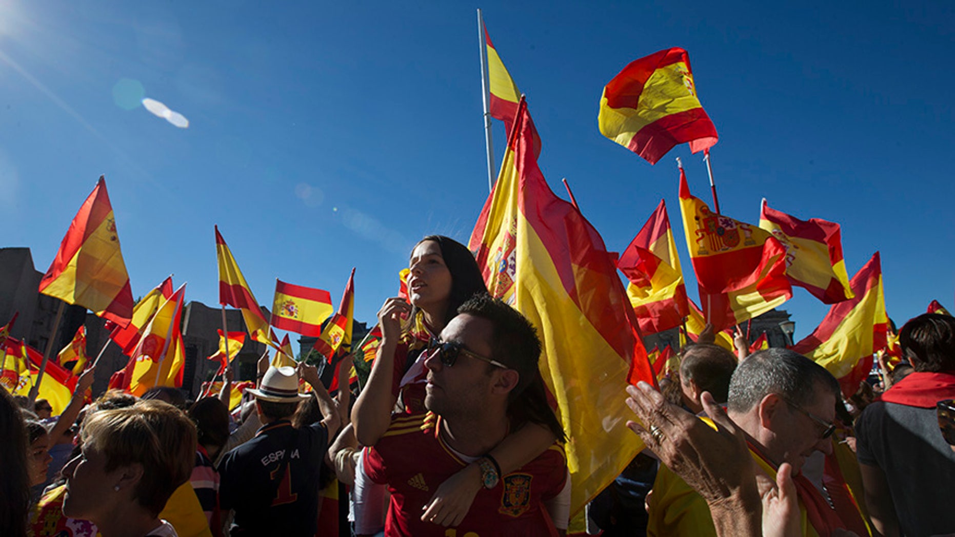 Spaniards pack Colon Square in Madrid, Spain, Saturday, Oct. 7, 2017. Thousands of pro-Spanish unity supporters donning Spanish flags have rallied in a central Madrid plaza to protest the Catalan regional government's drive to separate from Spain. (AP Photo/Paul White)