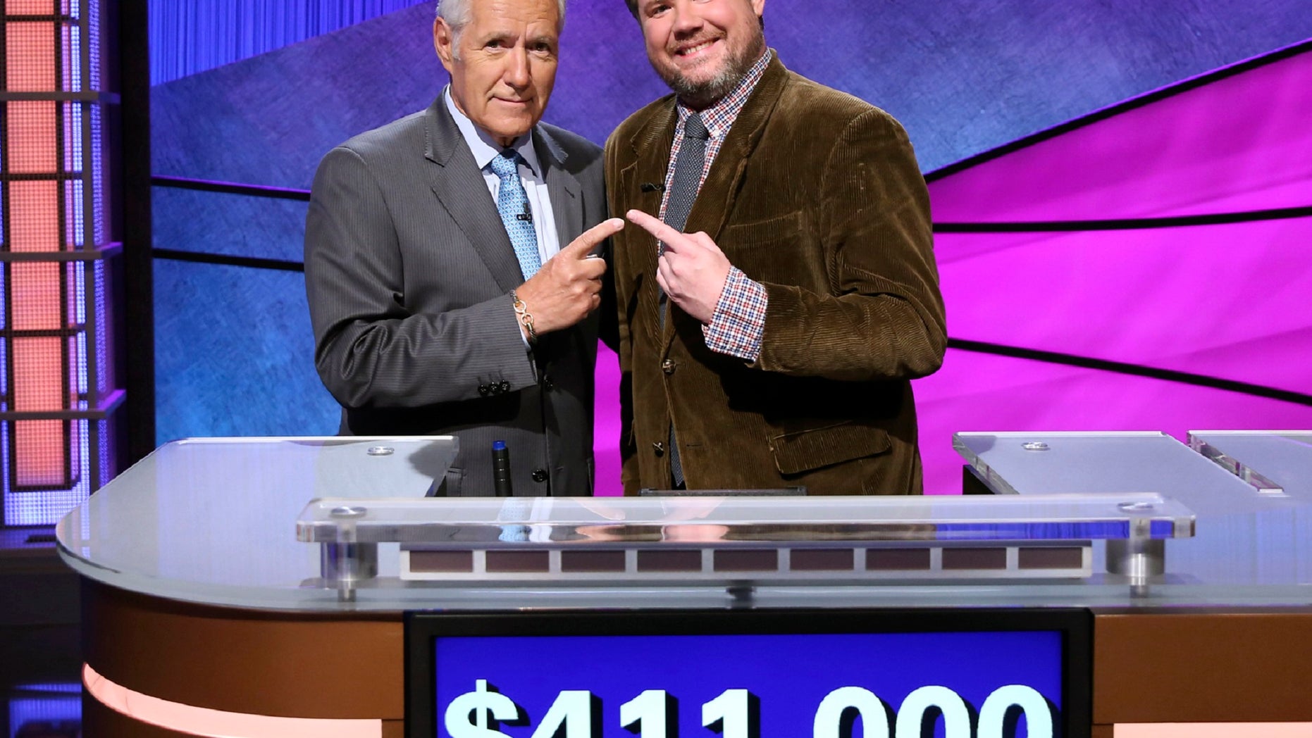 "Jeopardy!" contestant Austin Rogers, right, had a 12-game winning streak before losing by $51 Thursday night.