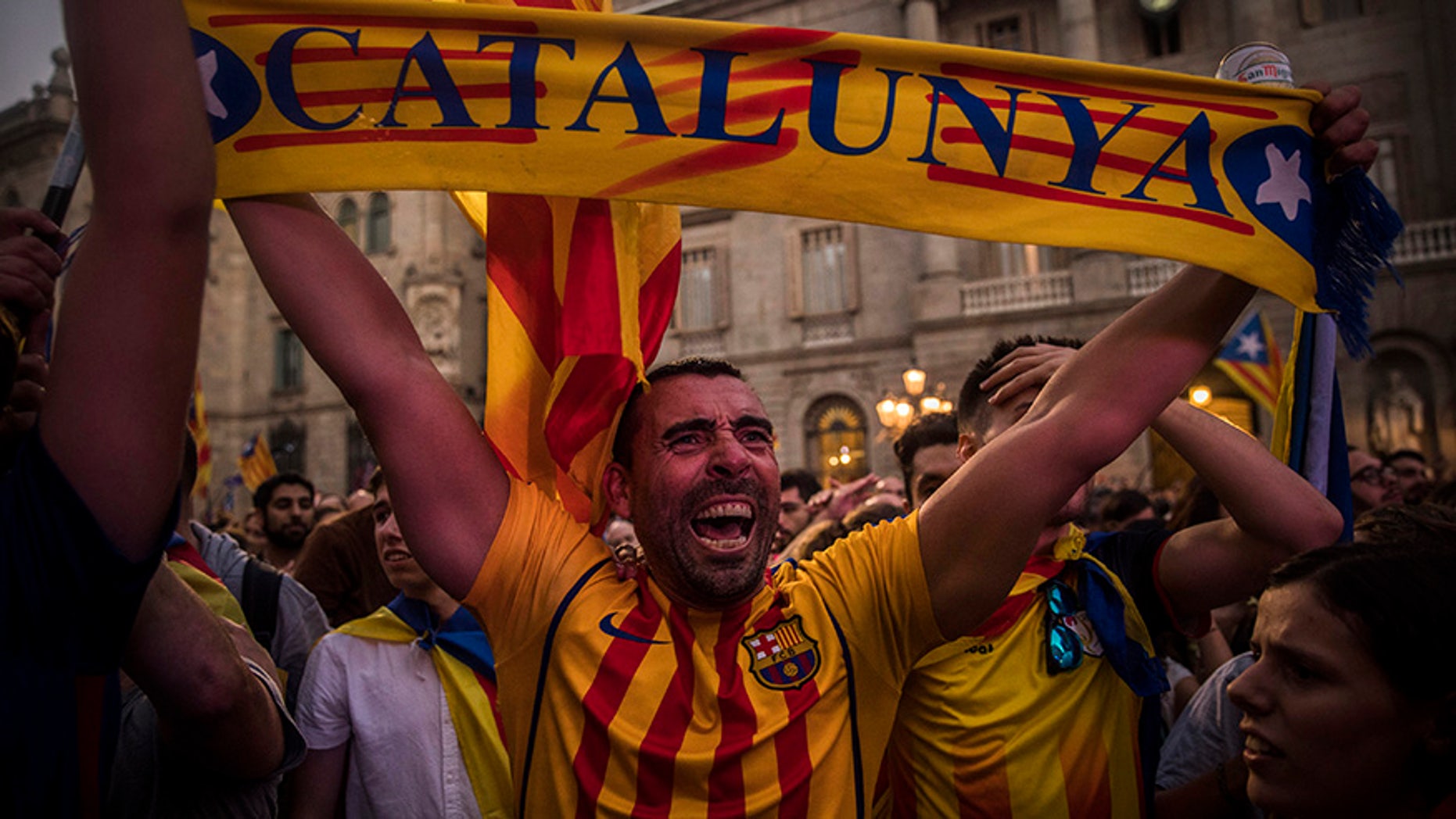 Pro-independence demonstrators cheer outside the Catalan parliament, in Barcelona, Oct. 27, 2017.