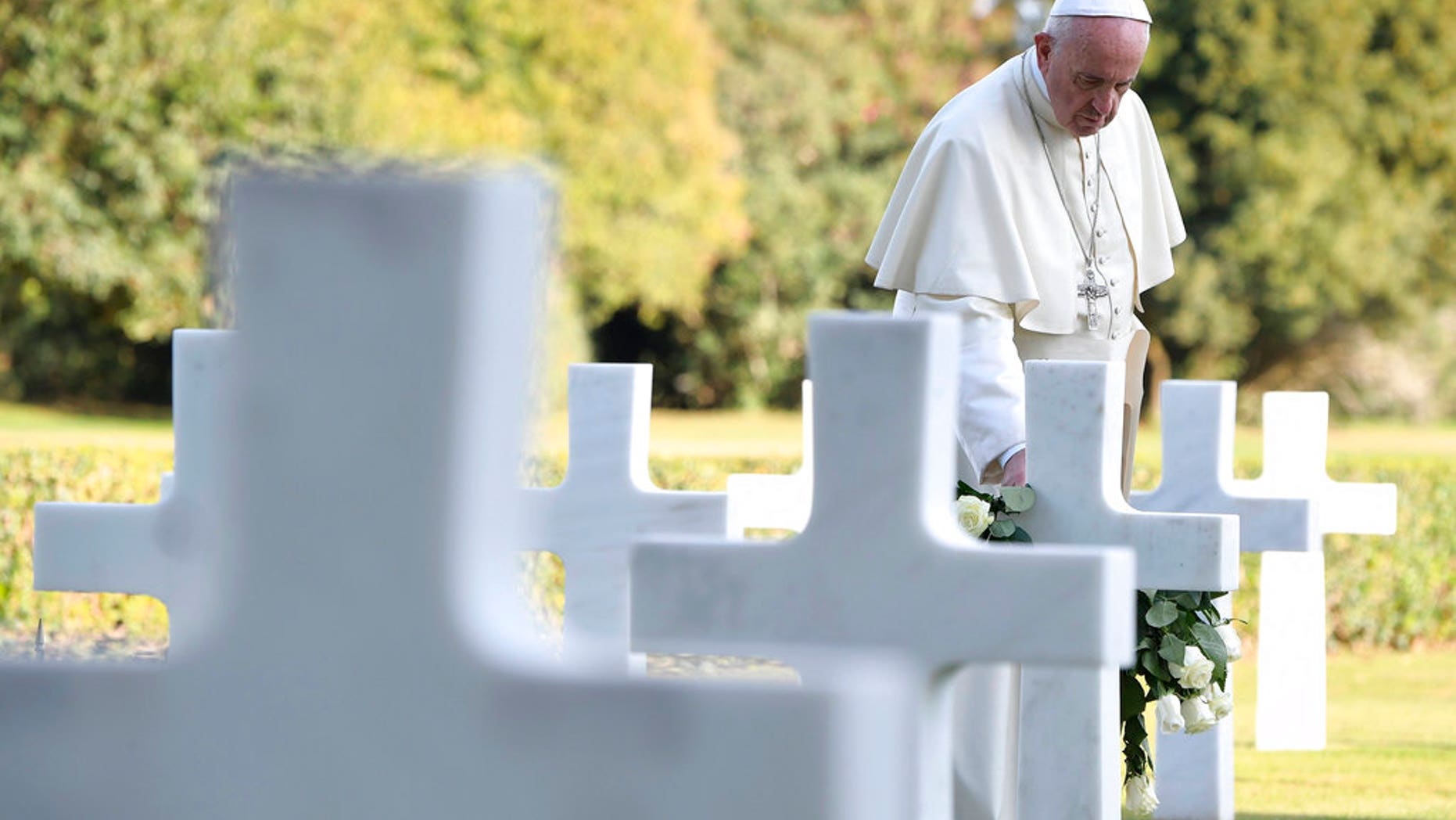 Pope Francis pays a visit to the American military cemetery in Nettuno, Italy, Thursday, Nov. 2, 2017. Pope Francis is underlining the price of war, visiting an American military cemetery and the site of a Nazi massacre in Rome. The pope will first say Mass in the Sicily-Rome American Cemetery, where 7,680 American war dead who helped liberate southern and central Italy during World War II are buried and 3,095 missing are commemorated. (L'Osservatore Romano/Pool Photo via AP)