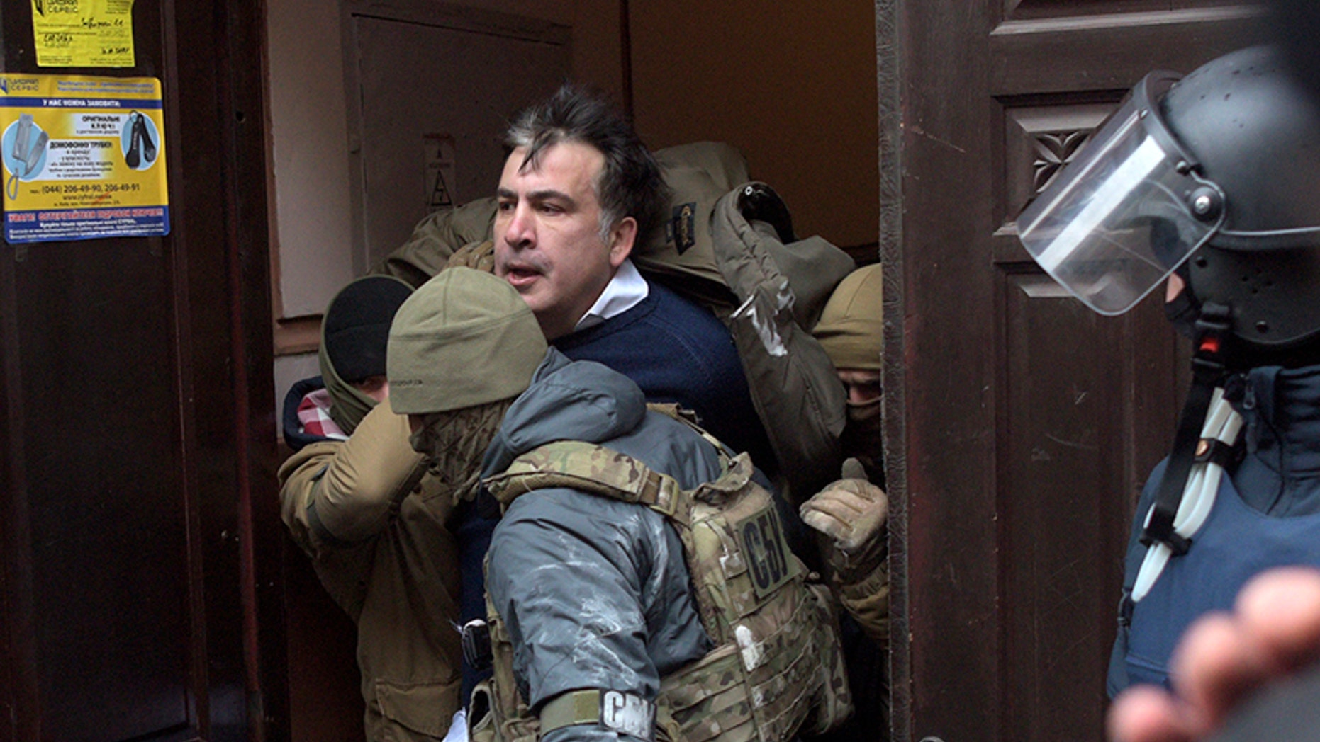 The Ukrainian Security Service officers detain Mikheil Saakashvili at the entrance of his house in Kiev, Ukraine.
