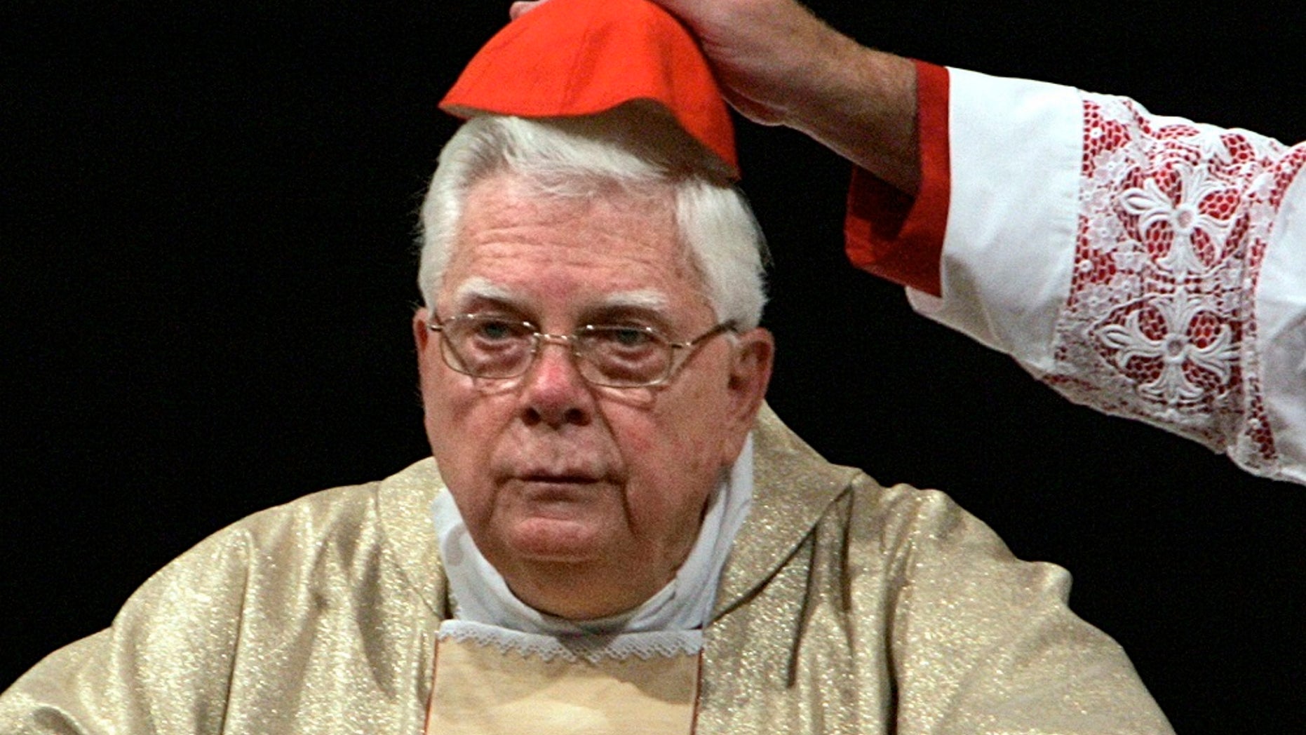Cardinal Bernard Law has his skull cap adjusted during a ceremony in St. Mary Major's Basilica in Rome, Aug. 5, 2004.