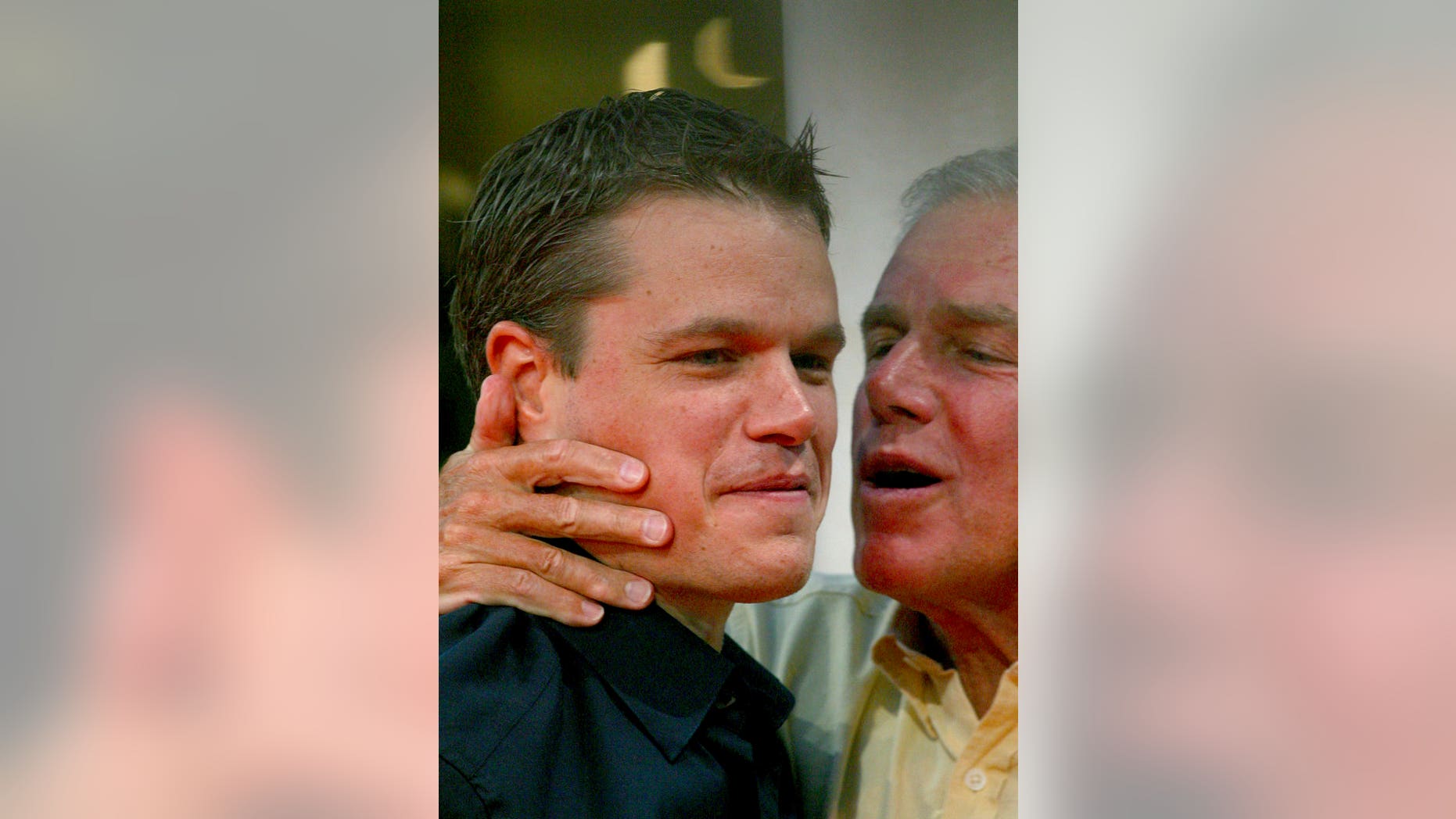 In this Sept. 5, 2004 file photo, Matt Damon is kissed by his father, Kent , before the screening of the film "The Bourne Supremacy" at the 30th American Film Festival of Deauville, Normandy, France.