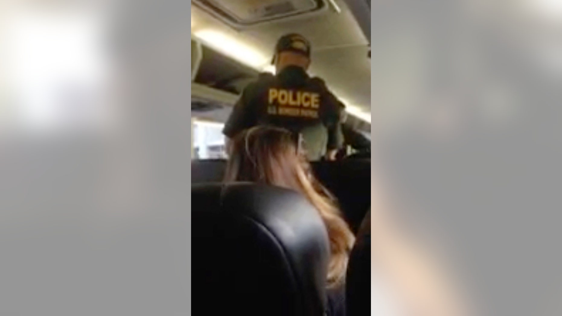 In this Friday, Jan. 19, 2018, image made from video, a Border Patrol officer requests identification of travelers on a Greyhound bus in Fort Lauderdale, Fla.