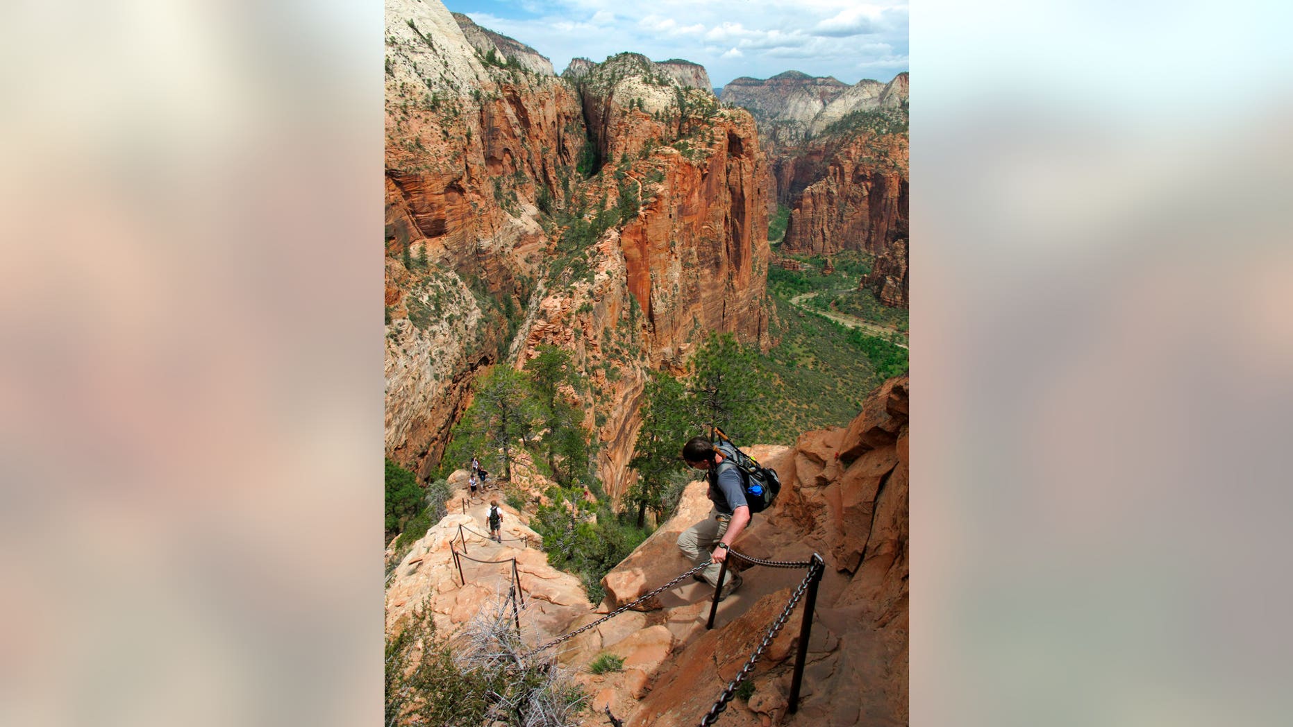 Hikers climb down the Angels Landing trail in Zion National Park, in Utah. Zion National Park officials say a 13-year-old girl has fallen to her death from a popular narrow trail bordered by steep drops.