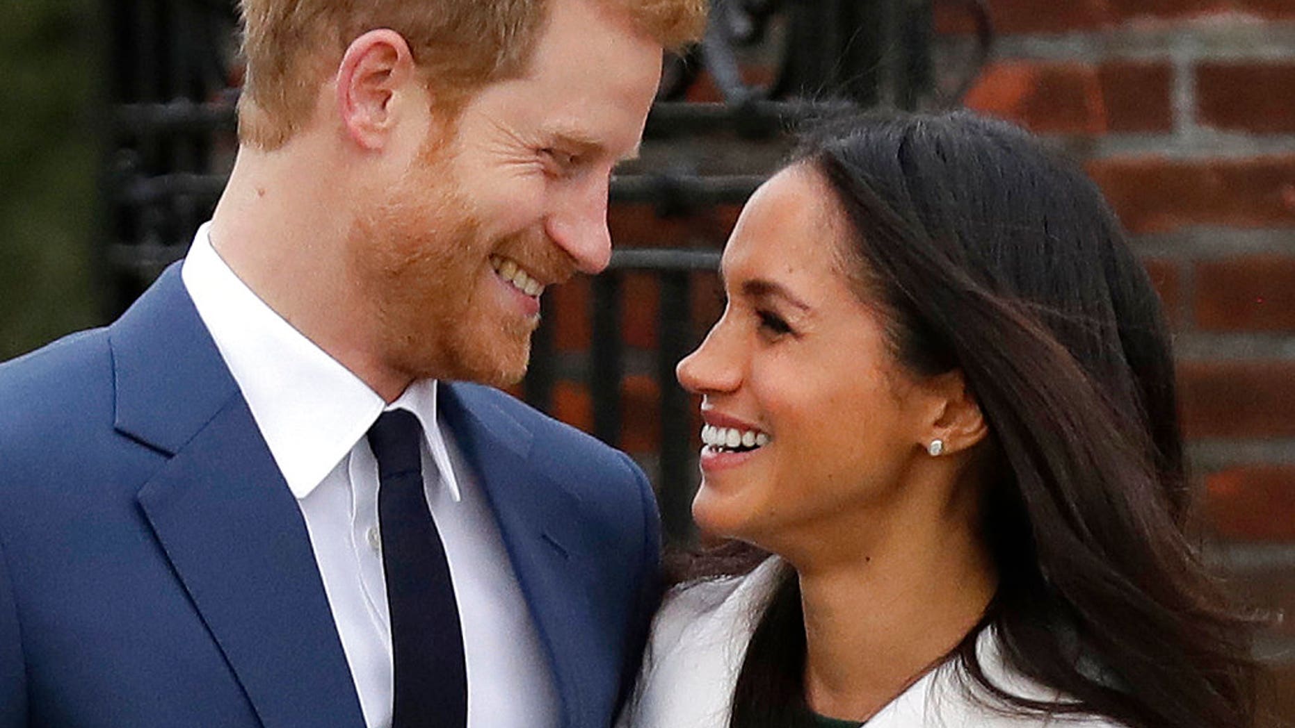 Britain's Prince Harry and his fiancee, Meghan Markle, on the grounds of Kensington Palace in London late last year. They are due to wed in May.