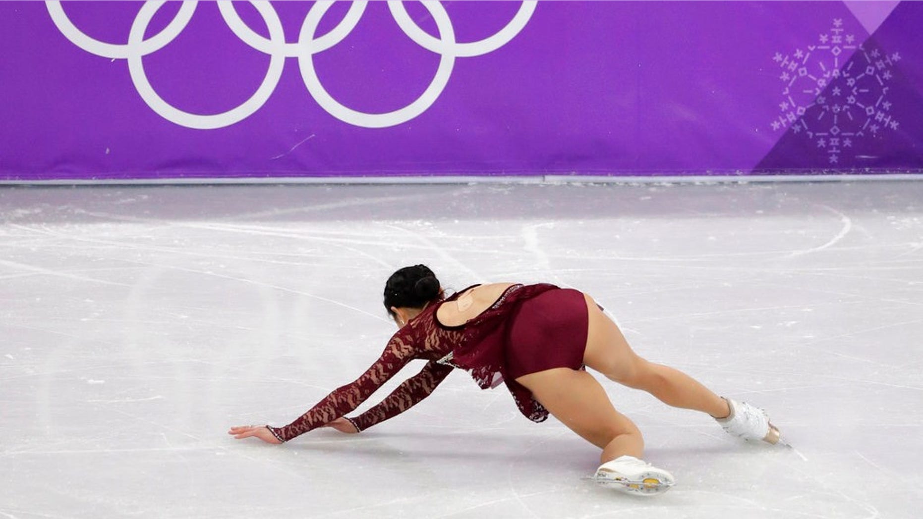 Mirai Nagasu falls while performing during the women's short program for figure skating.