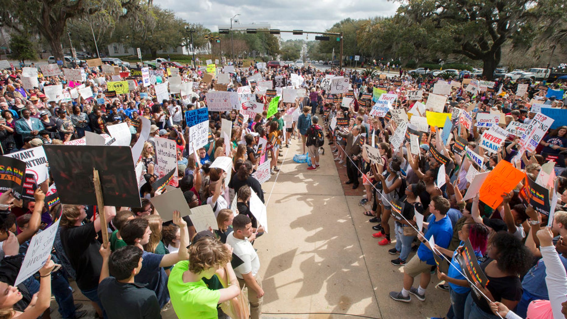 Students gather on the steps of the old Florida Capitol protesting gun violence in Tallahassee, Florida, on Wednesday. A school district in Texas has threatened to suspect students who participate in similar protest events.