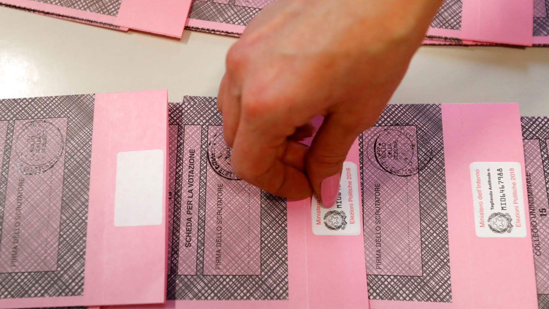 Polling station workers prepare ballots in Rozzano, near Milan, Italy, on Saturday.