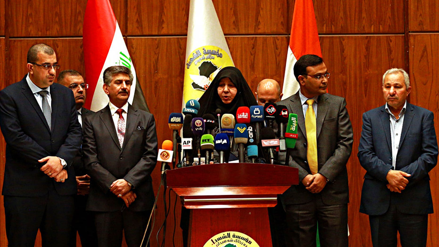 Najiha Abdul-Amir al-Shimari, center, the head of Iraq's Martyrs Establishment speaks during a press conference, in Baghdad, Iraq, Tuesday, March 20, 2018. Al-Shimari said Tuesday, that the bodies of 38 of the 39 Indians abducted by the Islamic State group in 2014 were found in a mass grave outside Mosul.