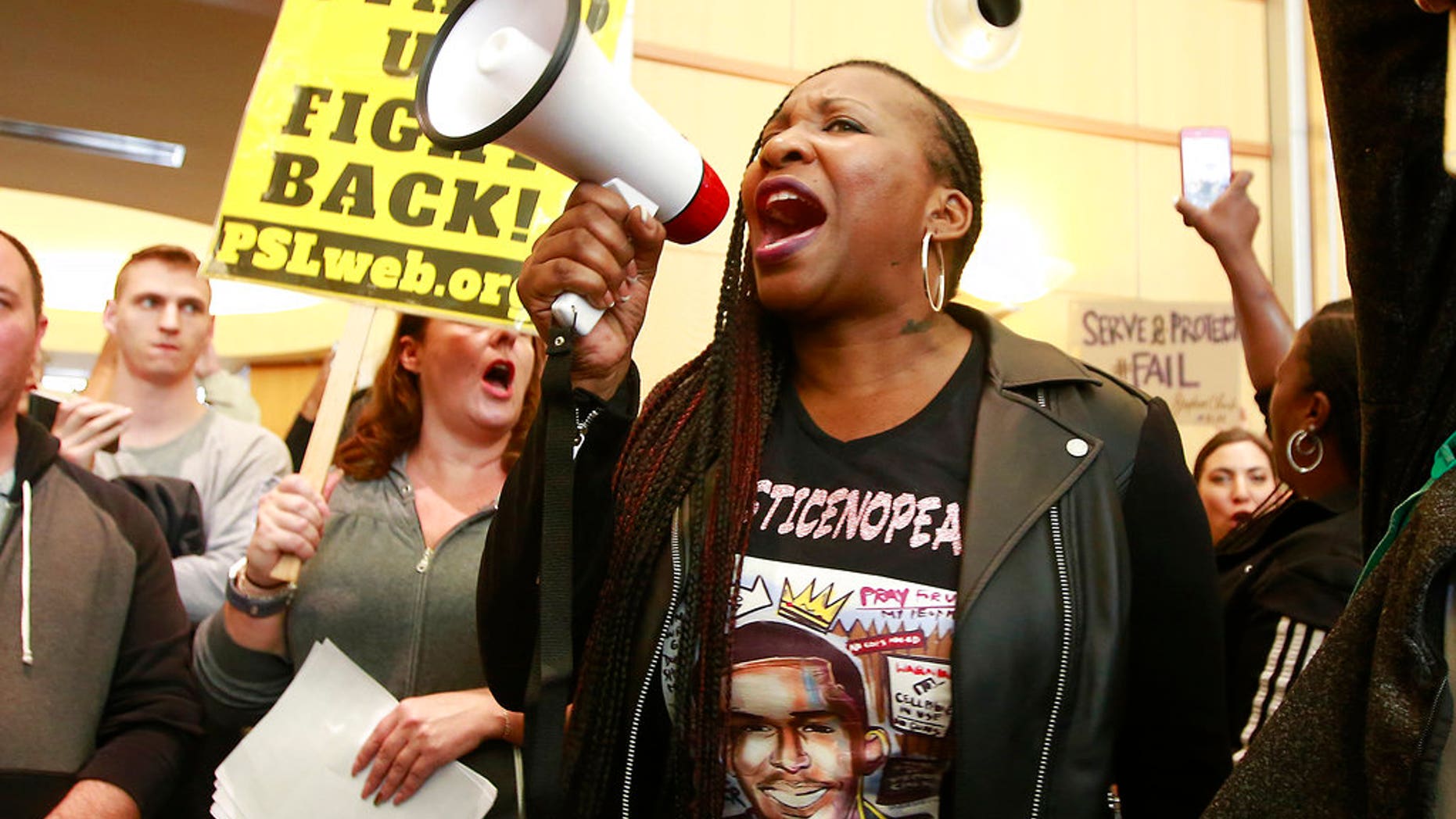 Veronica Curry and others protest the fatal shooting of Stephon Clark, outside City Hall in Sacramento, Calif., March 22, 2018.
