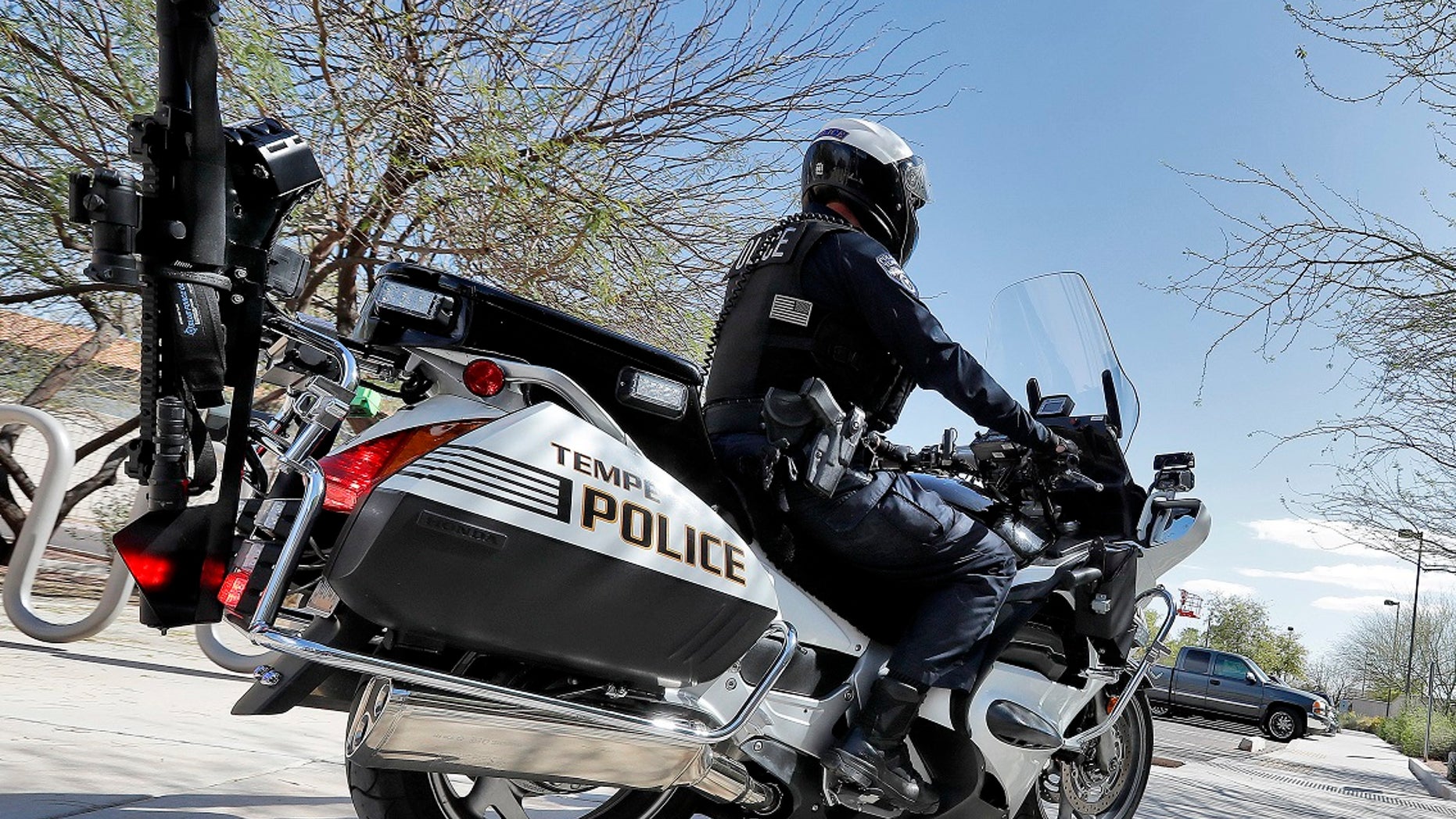 A Tempe, Ariz. police officer displays his AR-15 rifle that is carried on his motorcycle Tuesday, March 27, 2018. Tempe police have equipped eight motorcycle officers with AR-15 rifles and have stated that the weapons provide added security to ensure the officers are not outgunned by suspects.