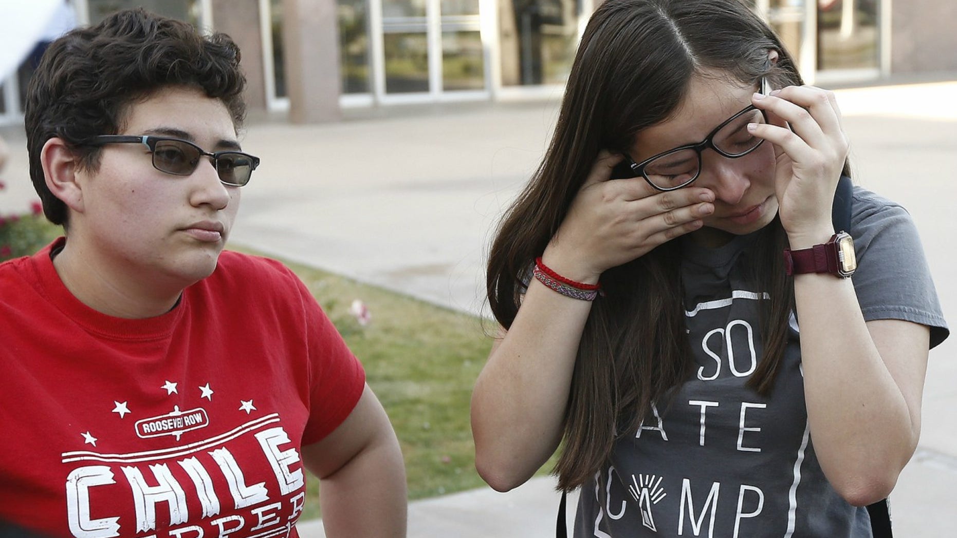 Darian Cruz, right, wipes away tears as she and Jasmin Lopez, left, listen to a friend talk about the Arizona Supreme Court ruling against young immigrants granted deferred deportation status under the 2012 Deferred Action for Childhood Arrivals program, during a demonstration at the Arizona Capitol in Phoenix, April 9, 2018.