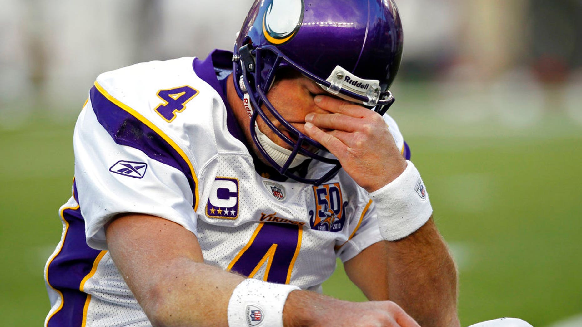 FILE 2010: Minnesota Vikings quarterback Brett Favre rubs his eyes after being hit by New England Patriots linebacker in Foxborough, Mass.