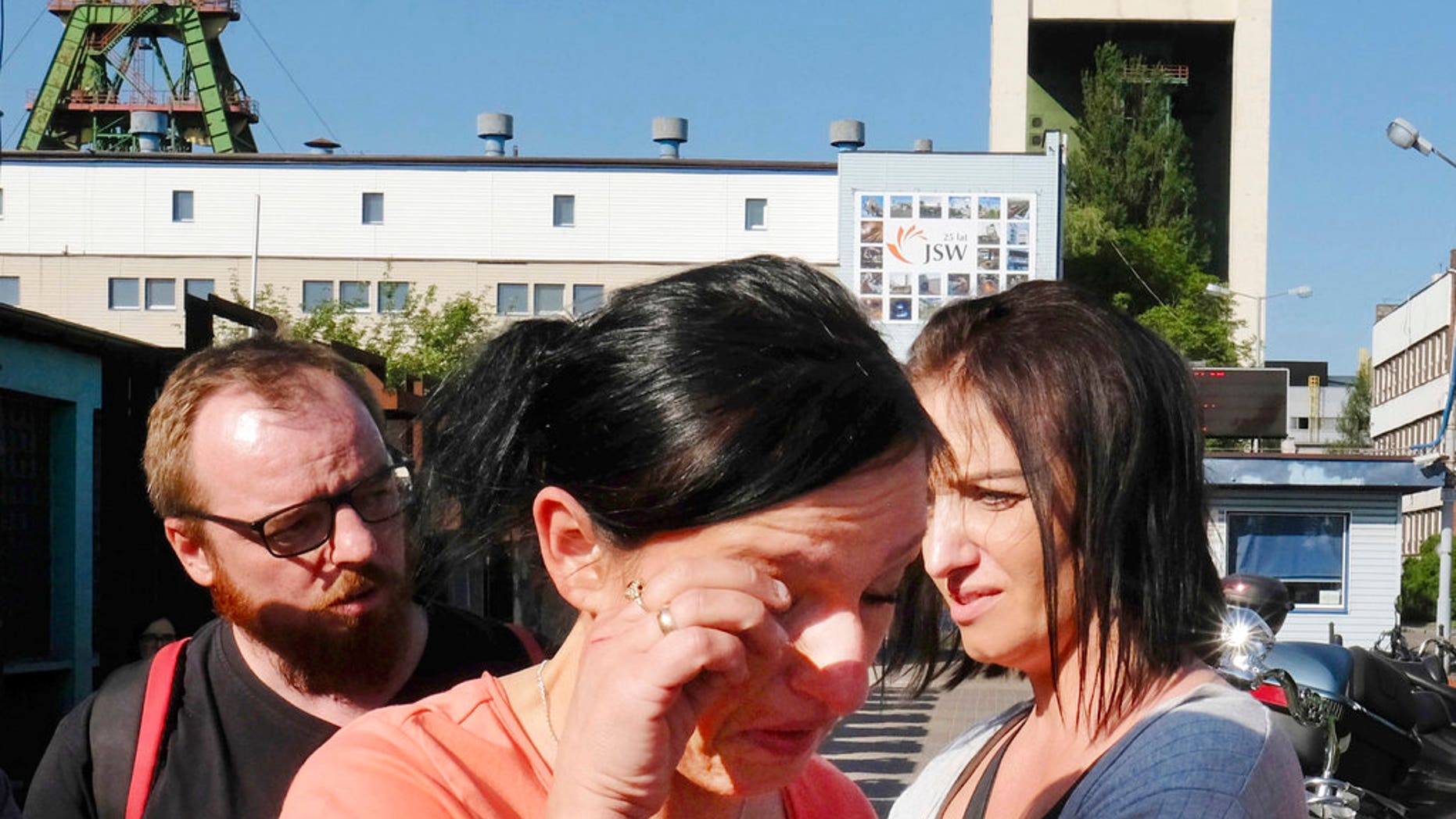 A woman cries outside the Zofiowka coal mine in Jastrzebie-Zdroj in southern Poland, where several miners were reported missing following a powerful earthquake, May 5, 2018.