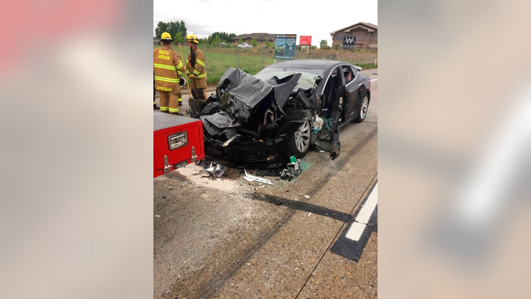 In this Friday, May 11, 2018, photo released by the South Jordan Police Department shows a traffic collision involving a Tesla Model S sedan with a Fire Department mechanic truck stopped at a red light in South Jordan, Utah. Witnesses indicated the Tesla Model S did not brake prior to impact. Police Sgt. Samuel Winkler said the car's air bags were activated and that the Tesla's 28-year-old driver suffered a broken right ankle, while the driver of the mechanic truck didn't require treatment. Police in a Salt Lake City suburb say it's not immediately known whether a Tesla Model S sedan's semi-autonomous Autopilot driving system was in use when it rear-ended a truck apparently without braking before impact at approximately 60 mph. (South Jordan Police Department via AP)