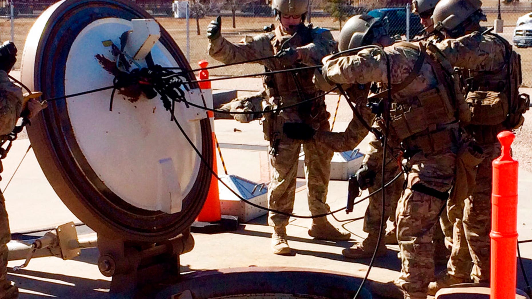 In this February 2016 photo, members of the 790th Missile Security Forces Squadron demonstrate their training for recapturing a Minuteman missile silo after being taken over by an intruder/attacker, just days before the Air Force announced the drug investigation, at the Francis E. Warren Air Force Base, near Cheyenne, Wyo.