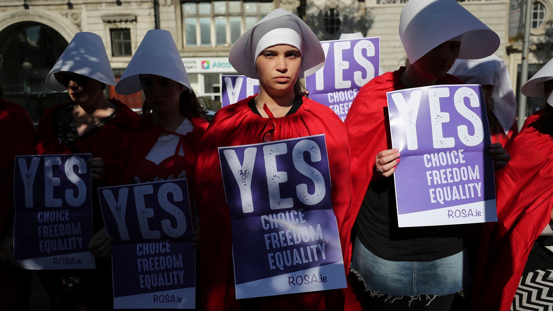 Volunteers from Reproductive rights, against Oppression, Sexism & Austerity (ROSA) dressed as characters from 'The Handmaid's Tale', demonstrate in Dublin, May 23, 2018.