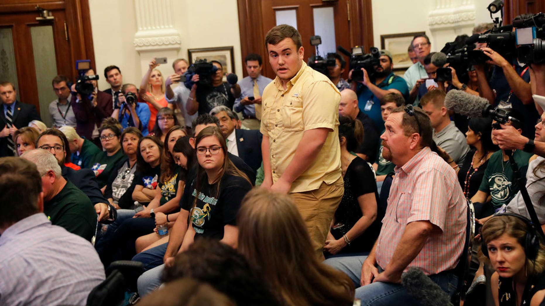 Tyler Morrison, center, a student at Santa Fe High School in Santa Fe, Texas, speaks during a roundtable discussion on gun violence, in Austin, Texas, May 24, 2018.
