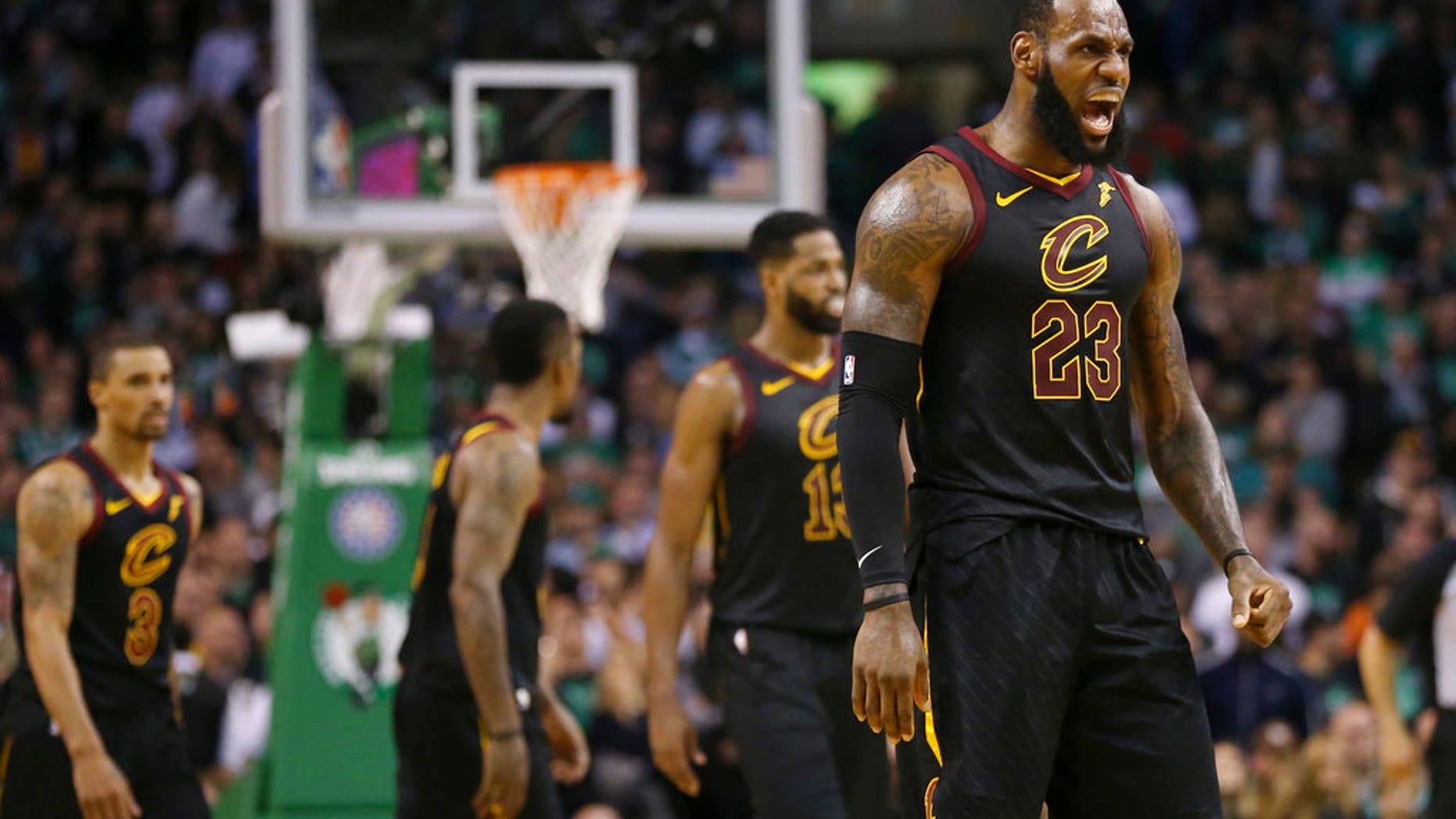 Cleveland Cavaliers forward LeBron James, right, celebrates a basket during the second half in Game 7 of the NBA basketball Eastern Conference finals against the Boston Celtics