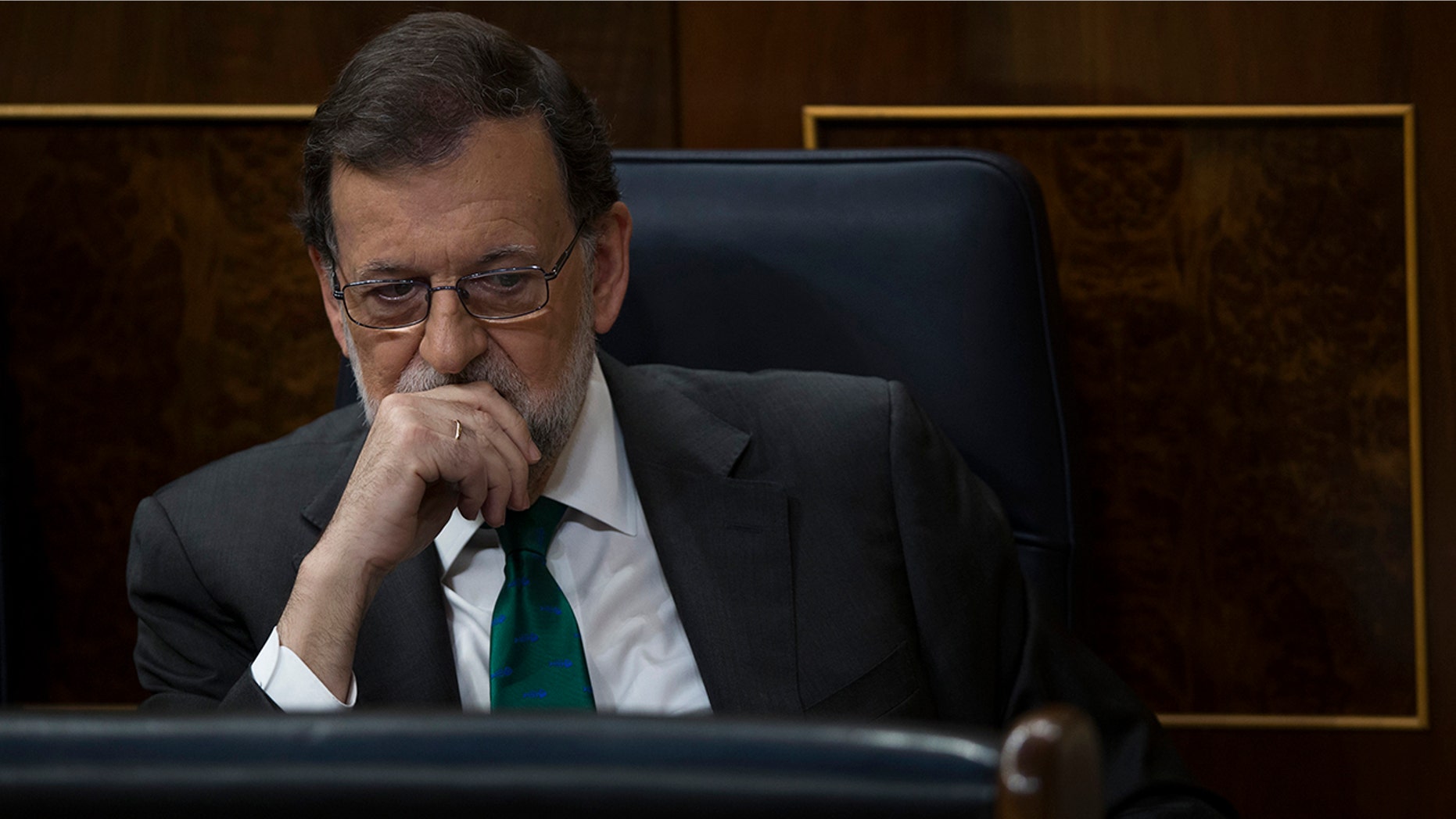 Spain's Prime Minister and Popular Party leader Mariano Rajoy listens to speeches during the first day of a motion of no confidence session at the Spanish parliament in Madrid.
