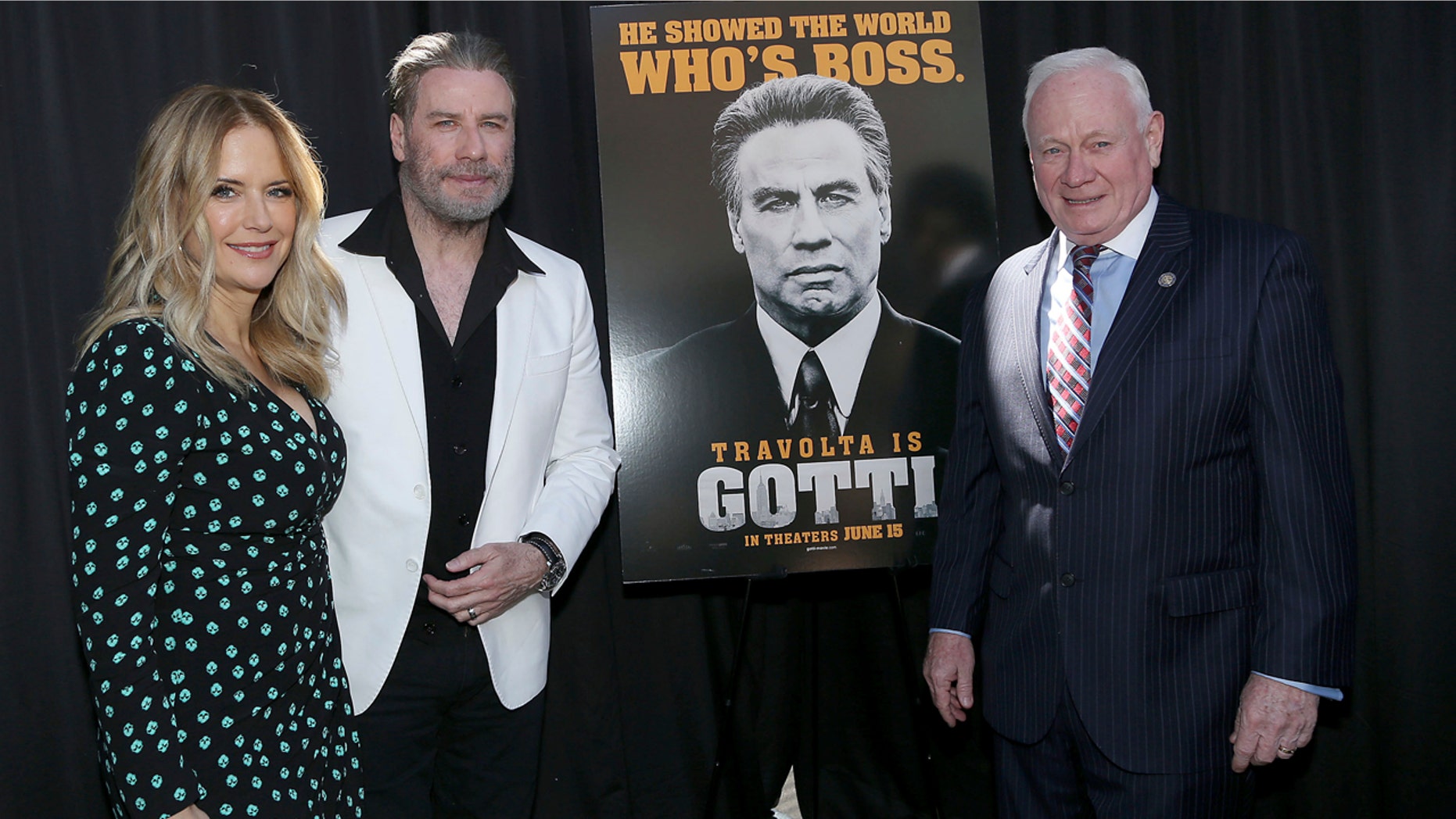 Actors Kelly Preston, left, and John Travolta, stars of the upcoming film, "Gotti," pose with New York state Sen. Marty Golden in Brooklyn, N.Y., June 12, 2018.
