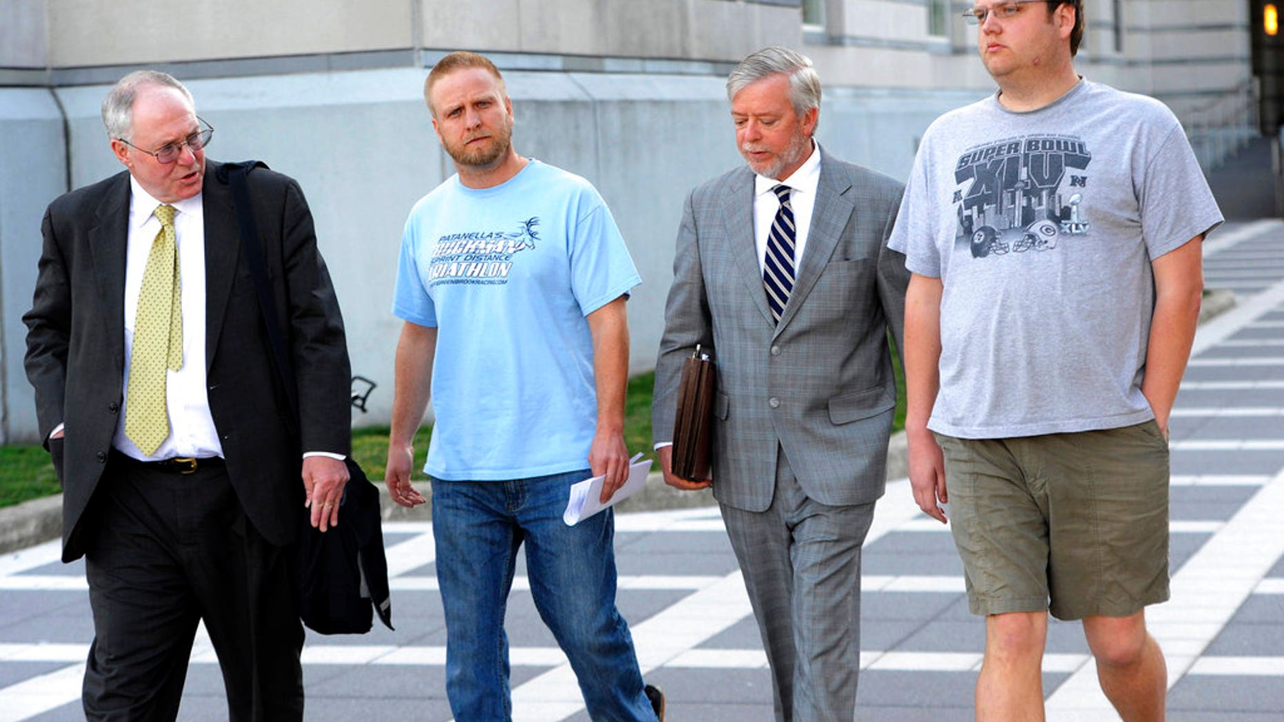 David Nicoll, second from left, and brother Scott Nicoll, right, leave a Newark, N.J., courthouse, accompanied by their representatives, in 2013.
