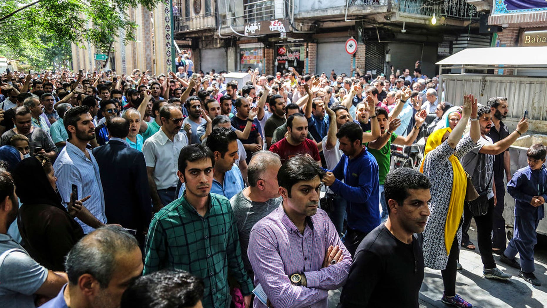 Iran has been beset by economic protests in recent days; a group of protesters chant slogans at the old grand bazaar in Tehran on Monday