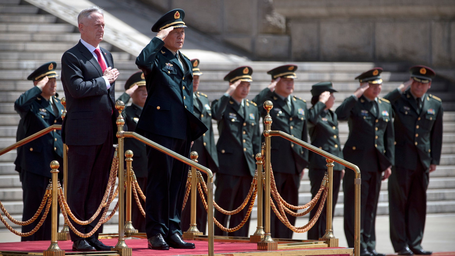 U.S. Defense Secretary Jim Mattis, front left, and China's Defense Minister Wei Fenghe stand as the American national anthem is played during a welcome ceremony at the Bayi Building in Beijing, Wednesday, June 27, 2018.