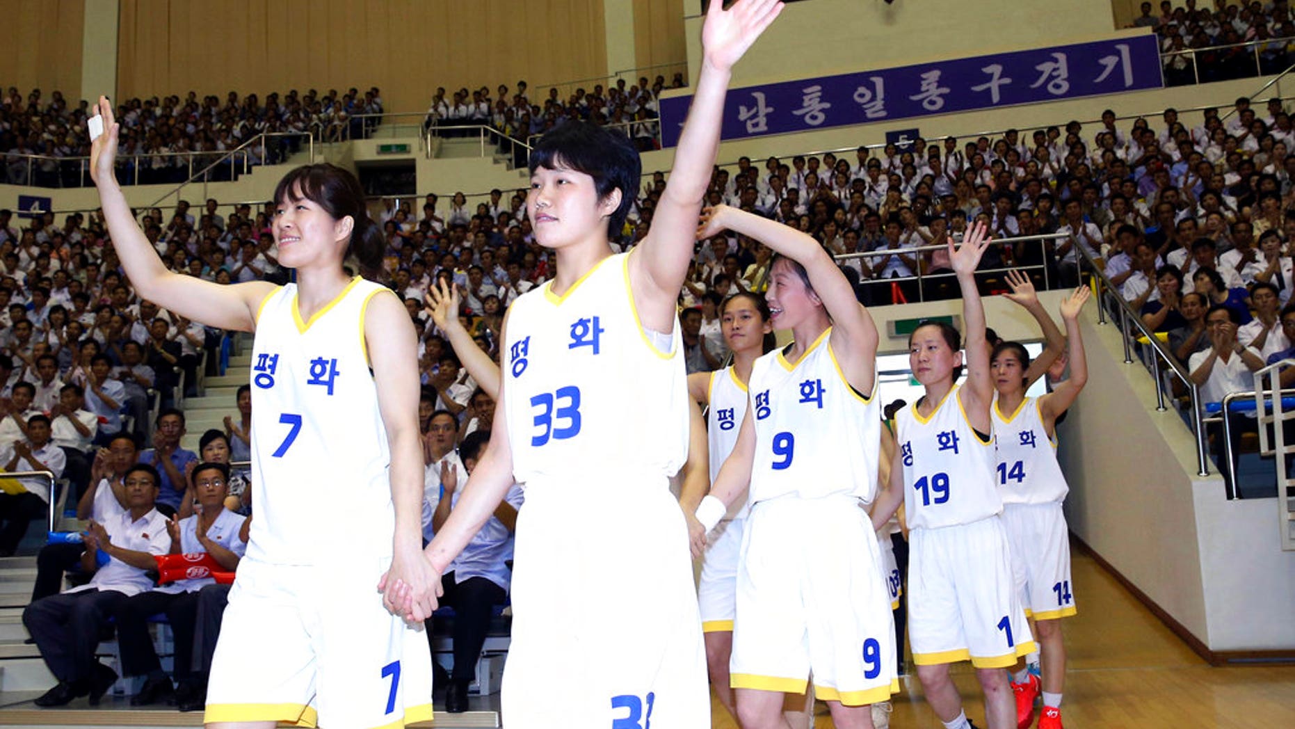 South and North Korean players of Team Peace wave as they arrive to play in a friendly basketball game at Ryugyong Jong Ju Yong Gymnasium in Pyongyang, North Korea, Wednesday, July 4, 2018.