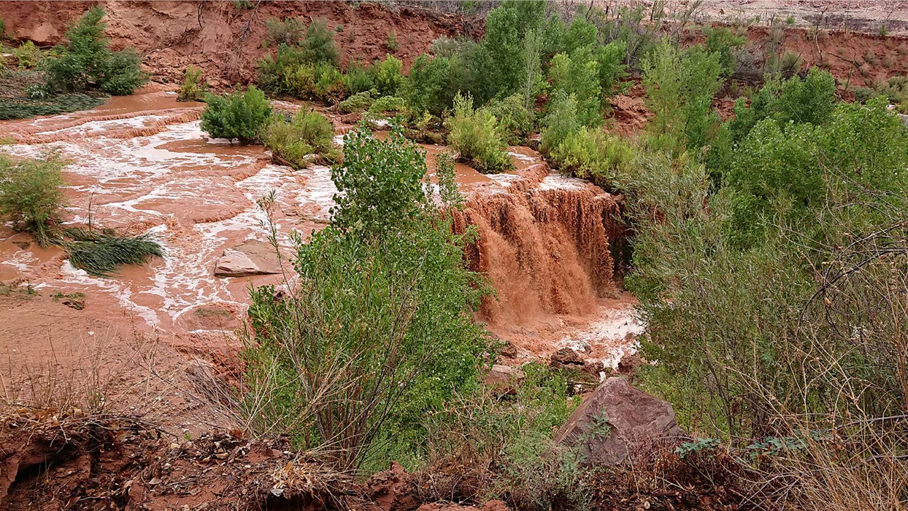 Flooding from a waterfall on the Havasupai reservation in Supai, Ariz., forced about 200 tourists to evacuated from a campground on tribal land near famous waterfalls deep in a gorge off the Grand Canyon, Thursday, July 12, 2018.
