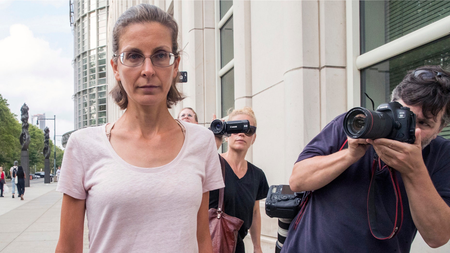 Clare Bronfman, left, leaves federal court, Tuesday, July 24, 2018, in the Brooklyn borough of New York.