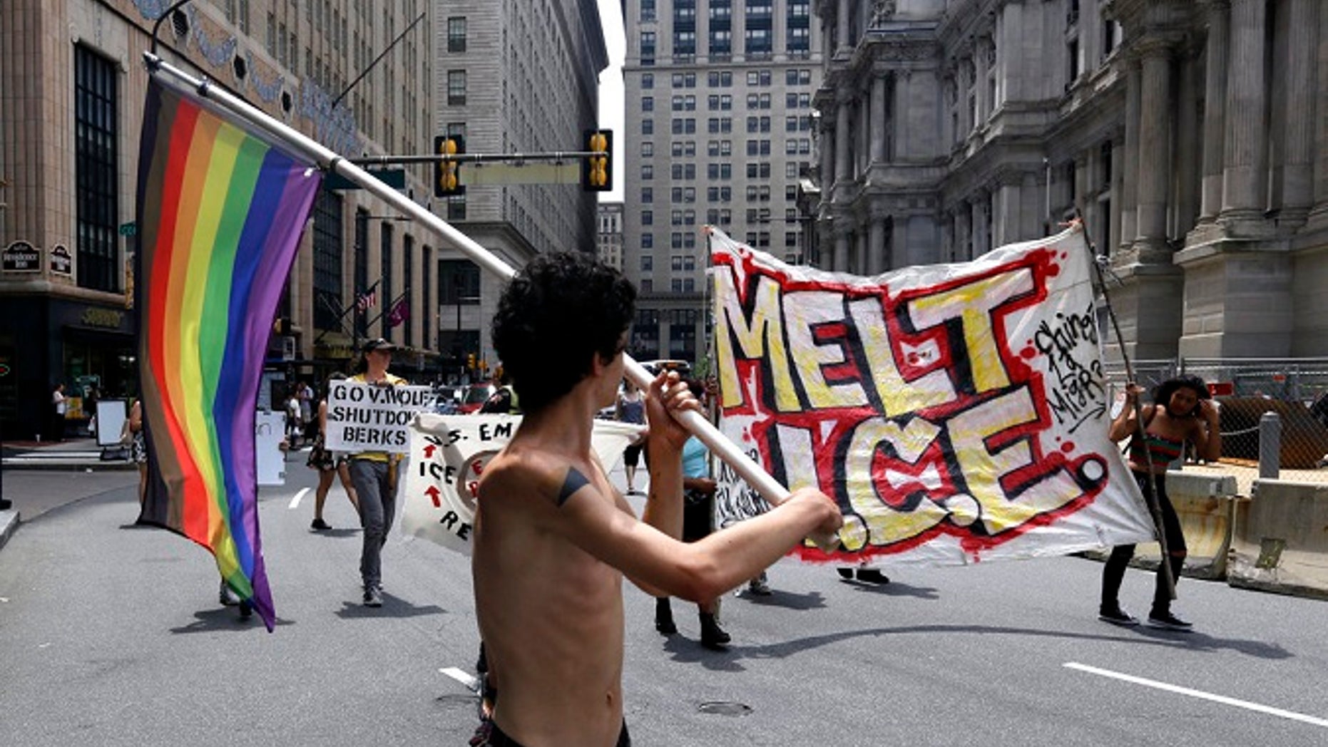 Protesters camped outside City Hall march in the street after a decision about ICE was made, Friday July 27, 2018, in Philadelphia. Mayor Jim Kenney announced Friday that Philadelphia will stop giving U.S. Immigration and Customs Enforcement (ICE) access to a real-time arrest database.