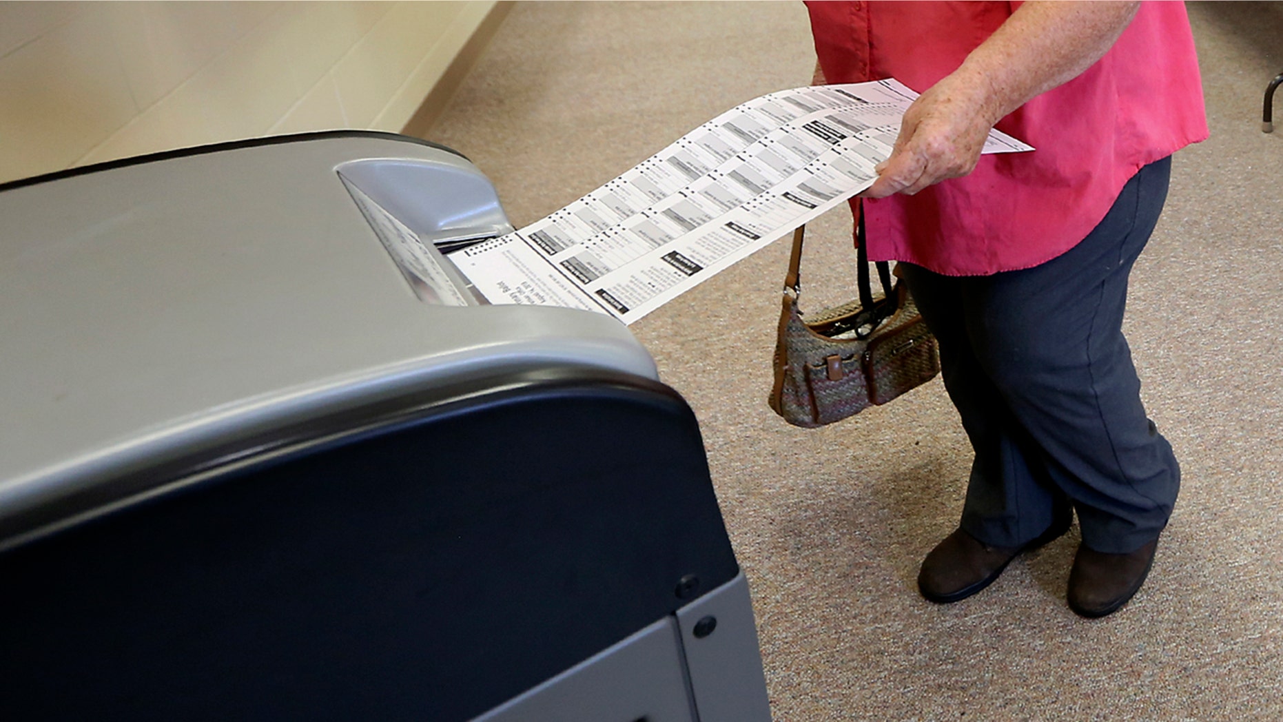 A voter casts her ballot in Wisconsin's primary election, Tuesday, Aug. 14, 2018.