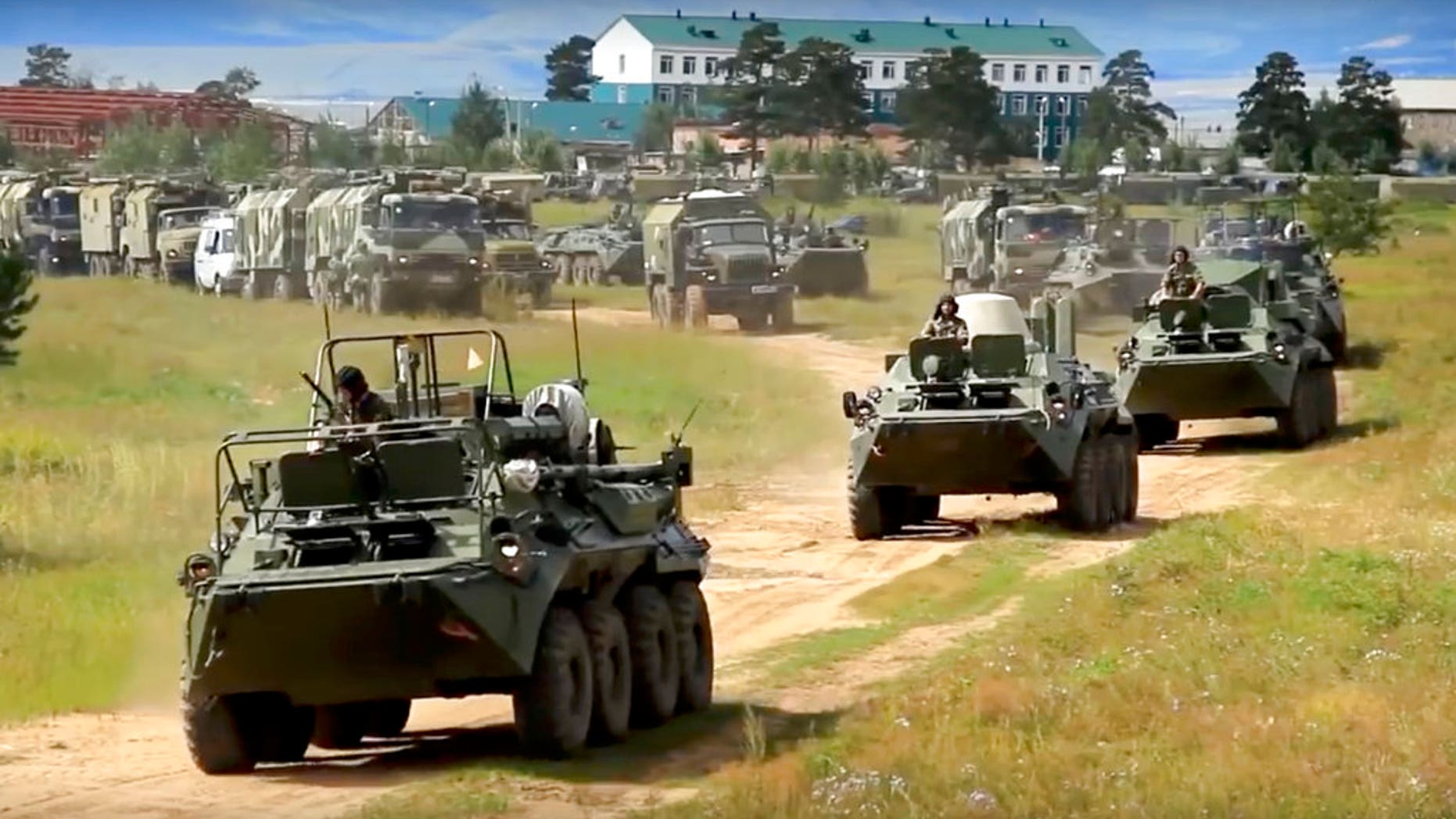 Russian armored personnel carriers roll during the military exercises in the Chita region, Eastern Siberia, during the Vostok 2018 exercises