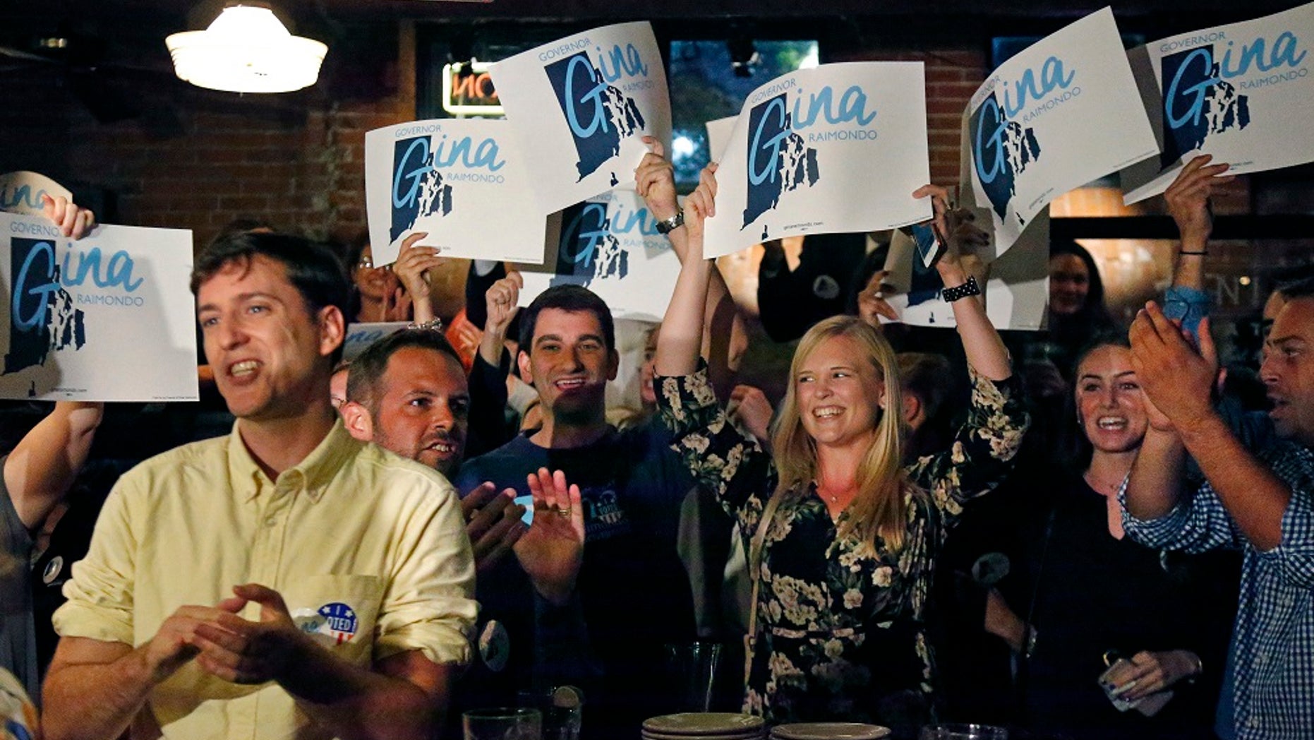 Supporters of incumbent Democratic Rhode Island Gov. Gina Raimondo cheer as they watch results on TV at her primary night party.