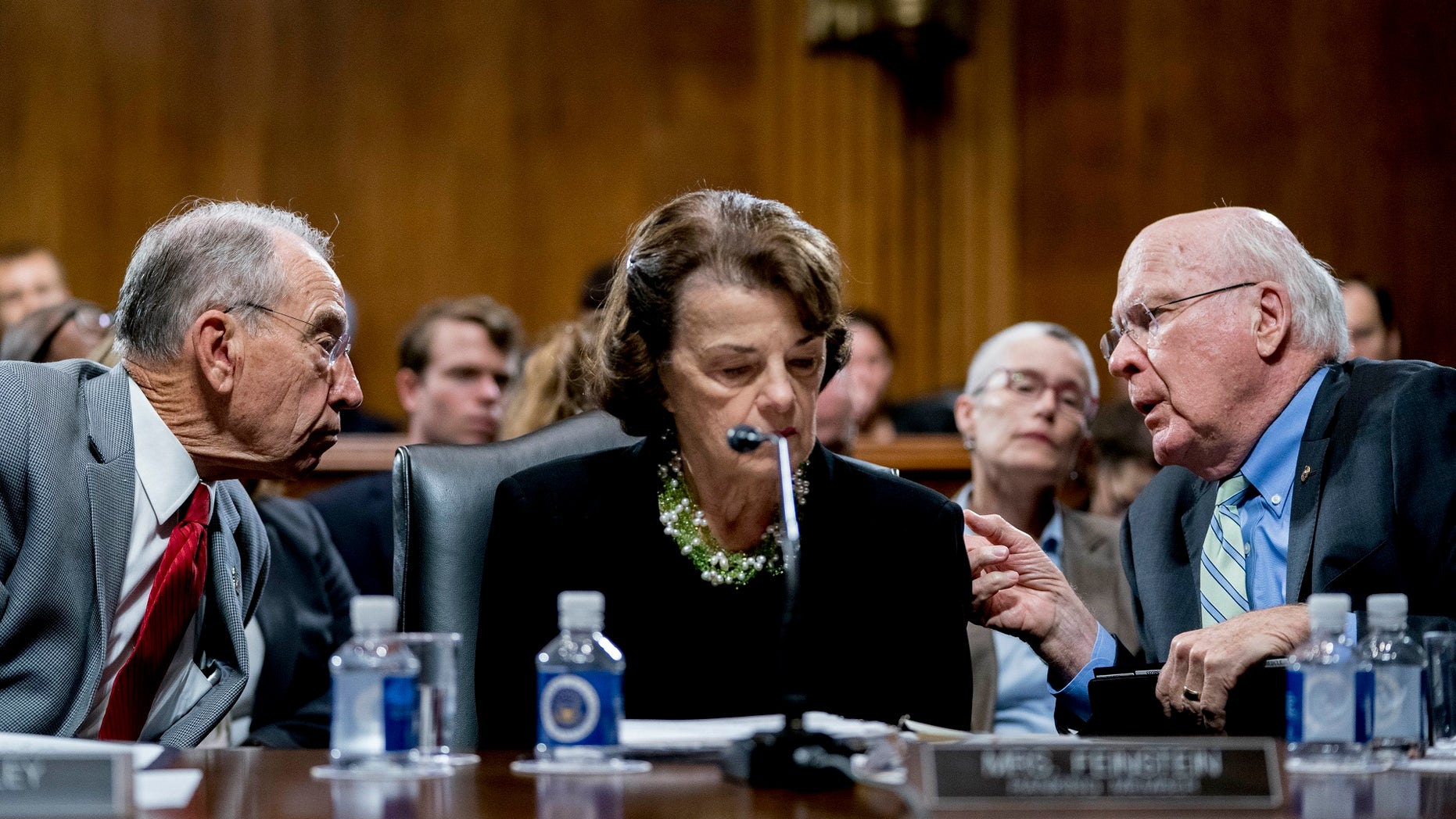 Senate Judiciary Committee Chairman Chuck Grassley (left) confers with other committee members, Sens. Patrick Leahy and Dianne Feinstein, the ranking member.