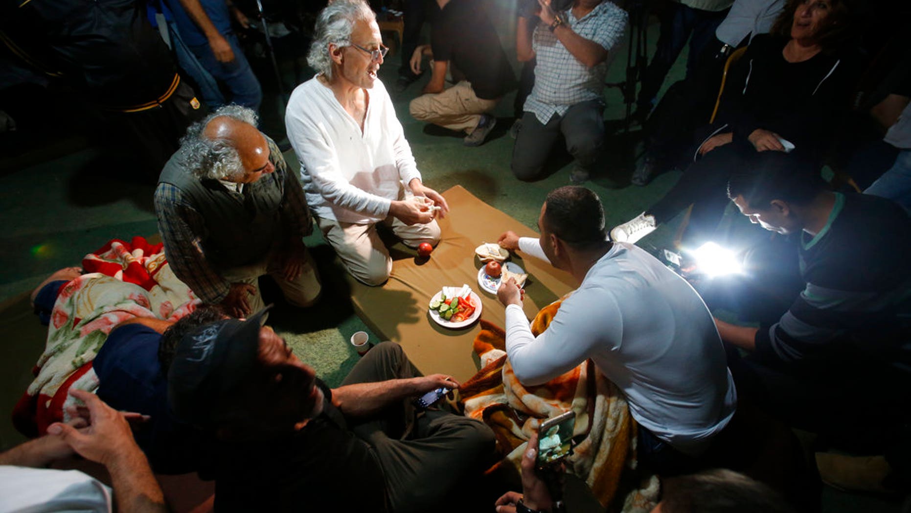 FILE: Frank Roimano is eating breakfast in the West Bank community of Khan al-Ahmar after being released from Israeli police custody.