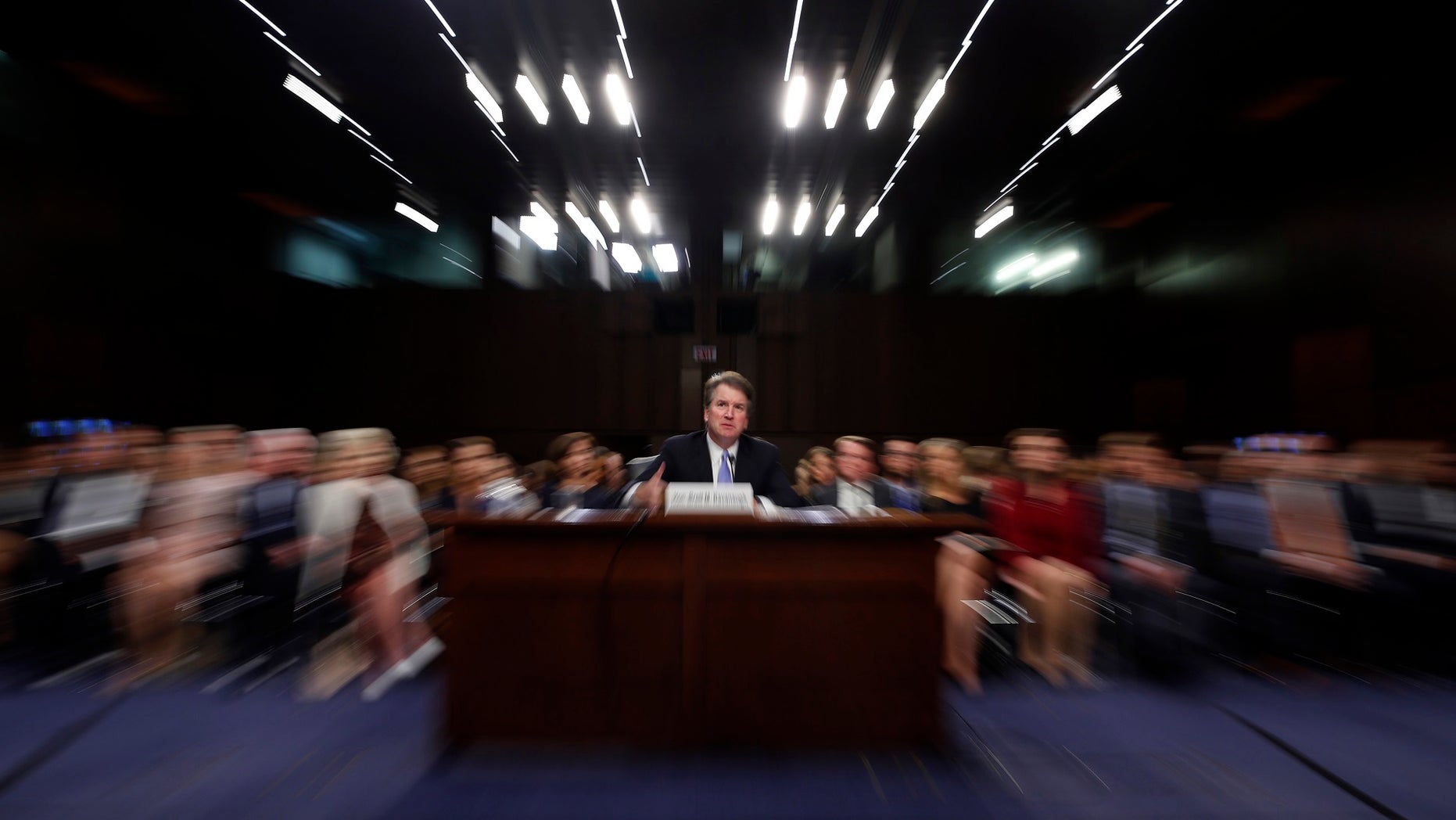 FILE - In this Thursday, Sept. 6, 2018 file photo made with a slow shutter speed and a zoom lens, President Donald Trump's Supreme Court nominee, Brett Kavanaugh testifies before the Senate Judiciary Committee on Capitol Hill in Washington, for the third day of his confirmation hearing. On Thursday, Sept. 20, 2018, an attorney for Christine Blasey Ford said she would testify to the Senate next week about her accusation that Kavanaugh assaulted her when both were high school students if agreement can be reached to "terms that are fair and which ensure her safety.â (AP Photo/Alex Brandon)