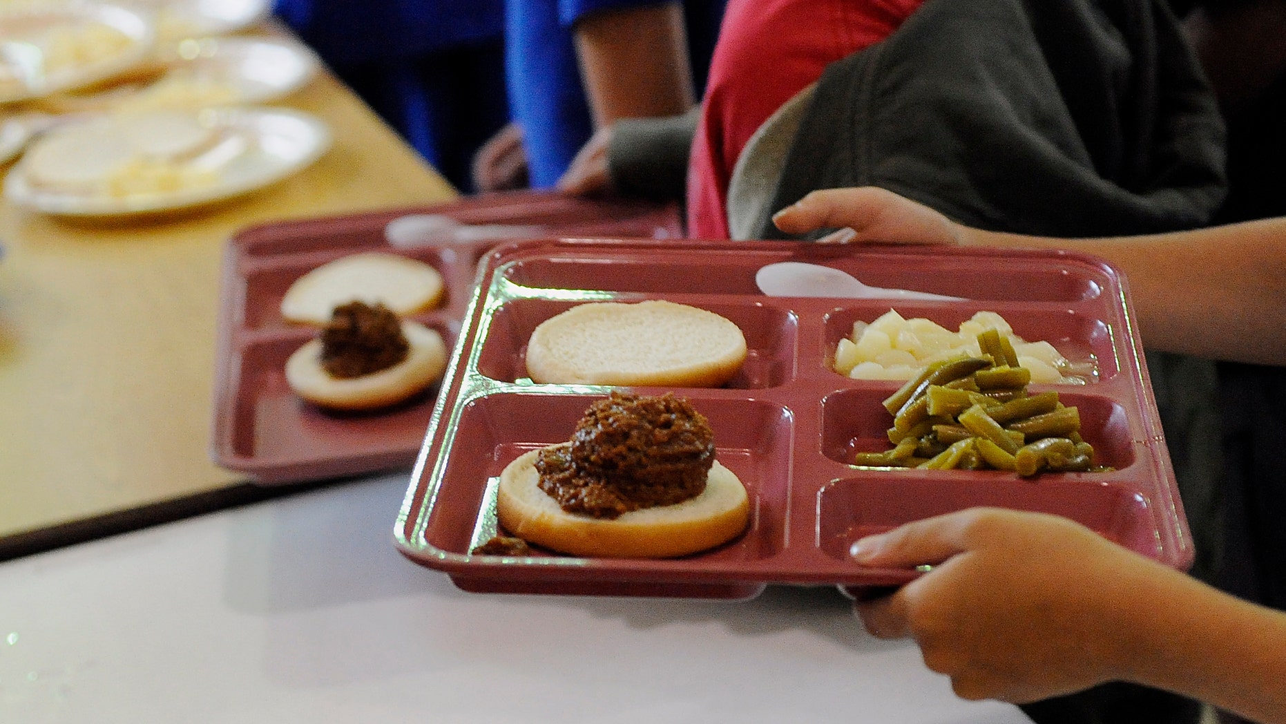 In this July 7, 2010 photo, a young boy carries his tray of food at lunch at the downtown YWCA in Sioux Falls, S.D. The food is gven out as part of the Summer Food Service Program designed for low-income children when they're not in school. (AP Photo/Argus Leader, Elisha Page)